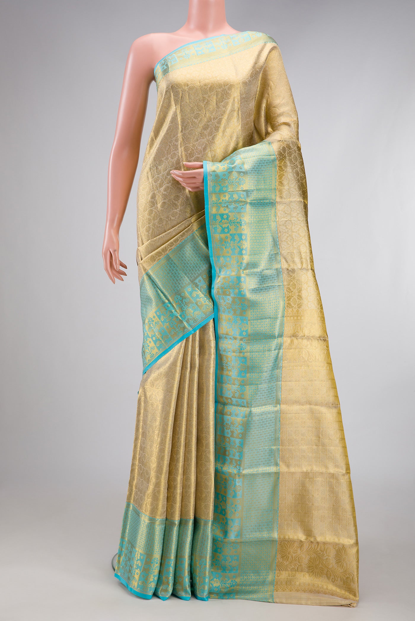 Gold Kanchipuram Tissue Silk Saree with Zari Brocade on the body and Fancy Border.  displayed on a mannequin