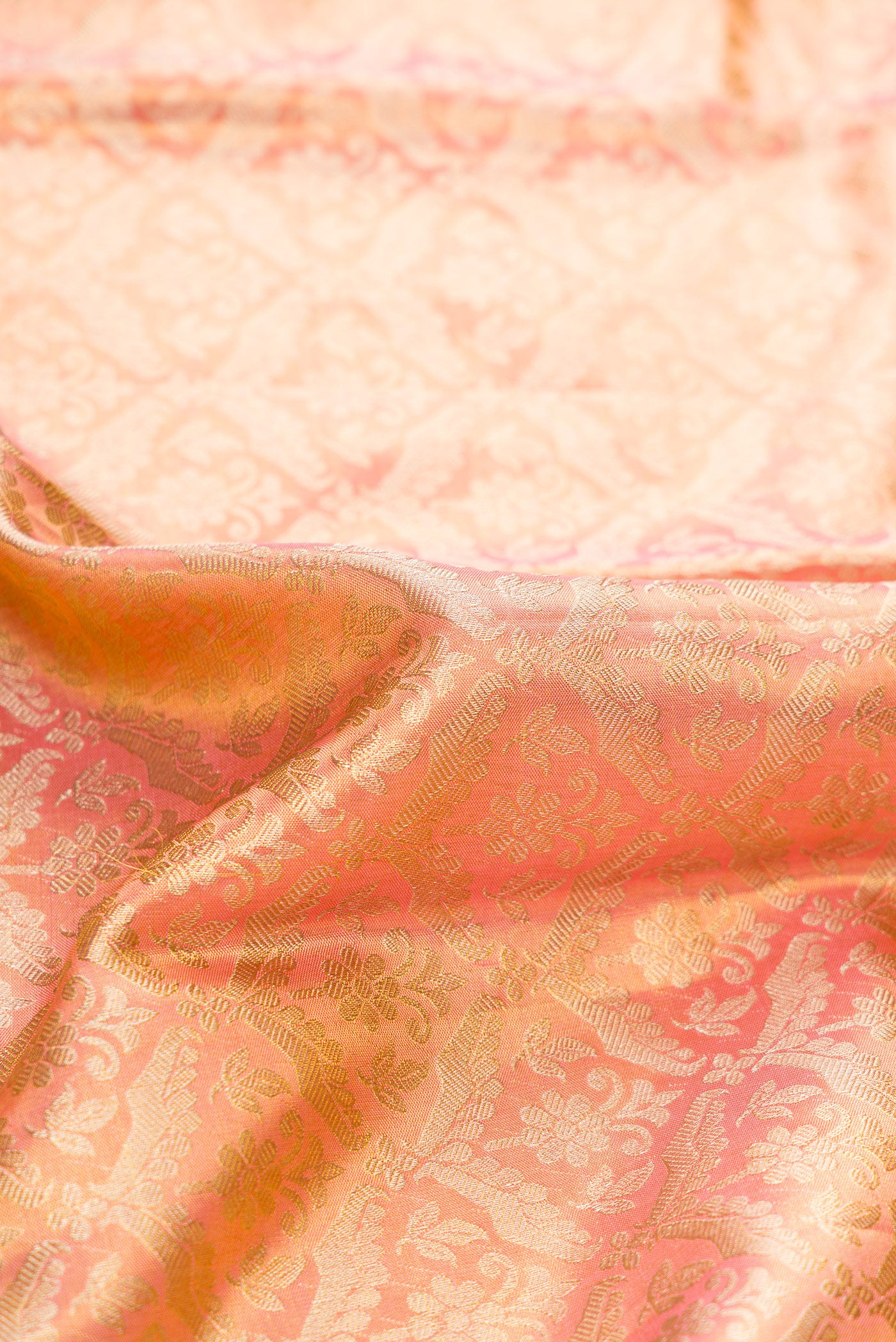 Close up of Pink Dual Tone Kanchipuram Tissue Silk Saree with Zari Brocade on the body and Zari Border.  displaying folds