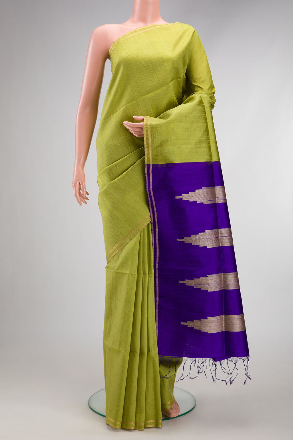 Pista Green Raw Silk Saree with Plain Body and Zari Border.  displayed on a mannequin