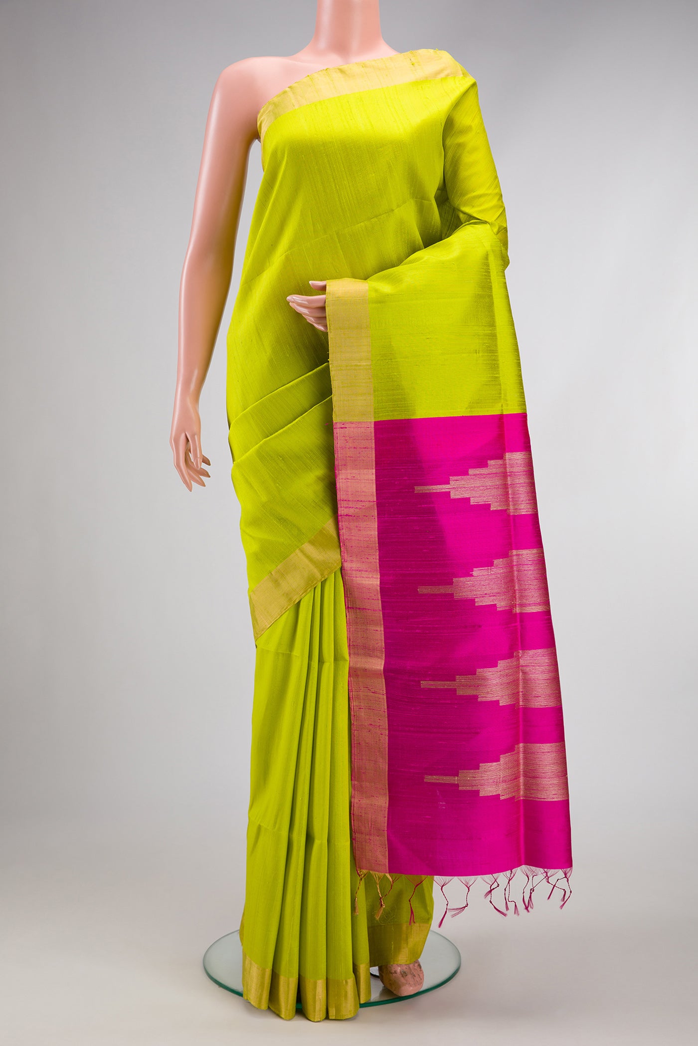 Parrot Green Raw Silk Saree with Plain Body and Zari Border.  displayed on a mannequin