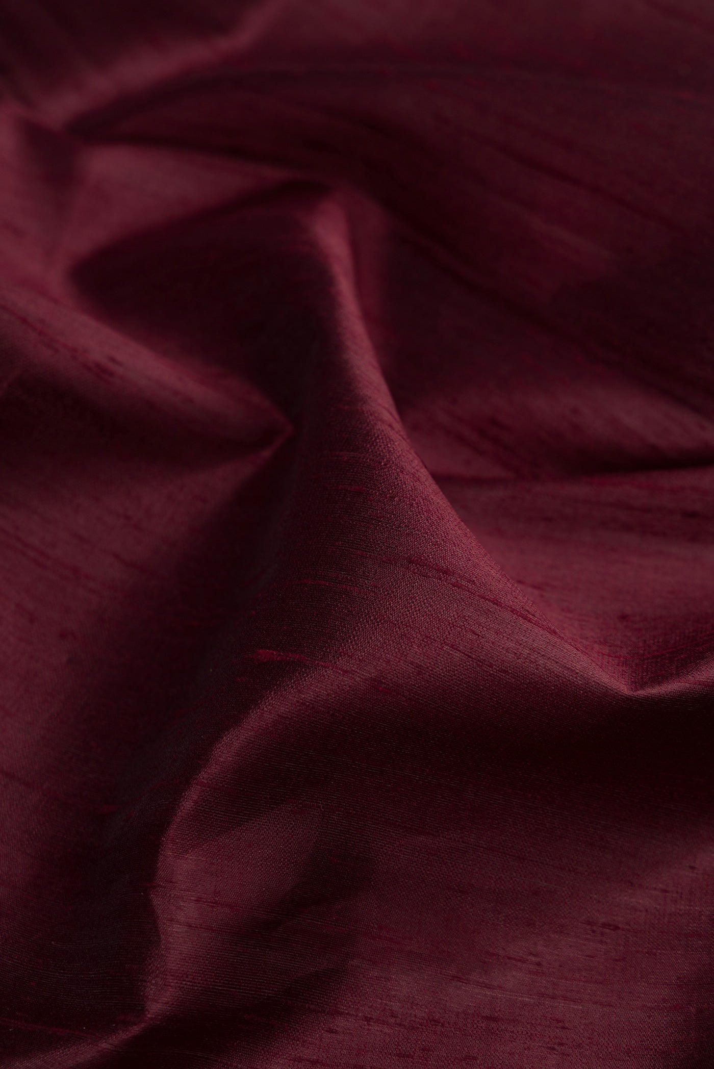 Close up of Coffee Brown Raw Silk Saree with Plain Body and Zari Border.  displaying folds