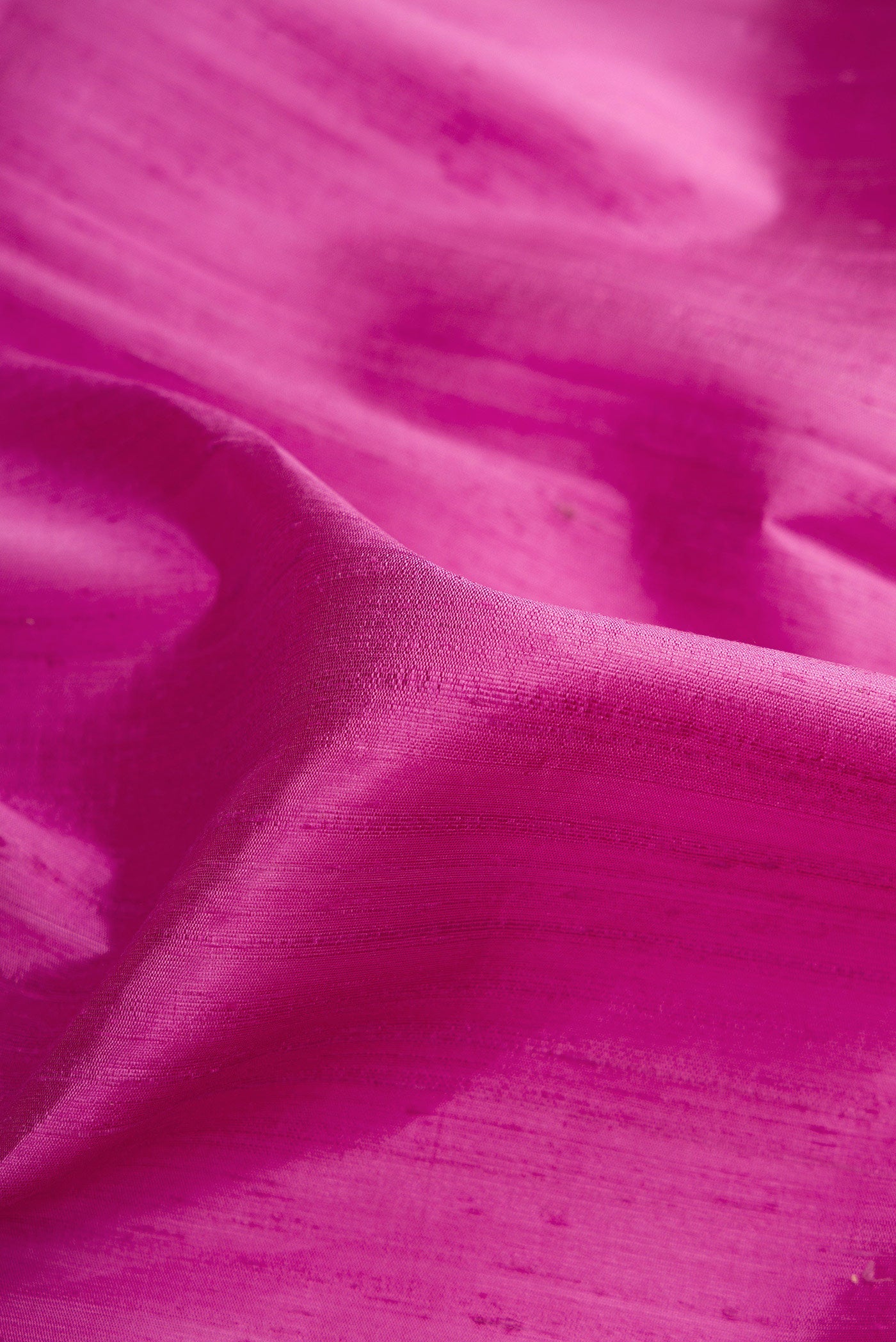 Close up of Lavender Raw Silk Saree with Plain Body and Zari Border.  displaying folds