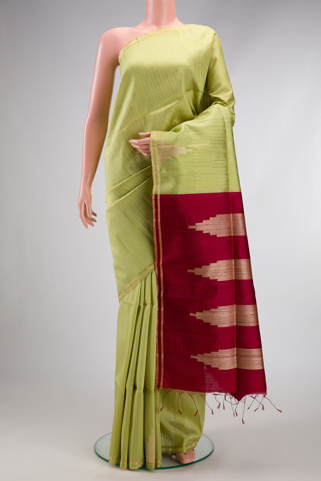 Pista Green Dual Tone Raw Silk Saree with Checked design on the body and Temple Border.  displayed on a mannequin