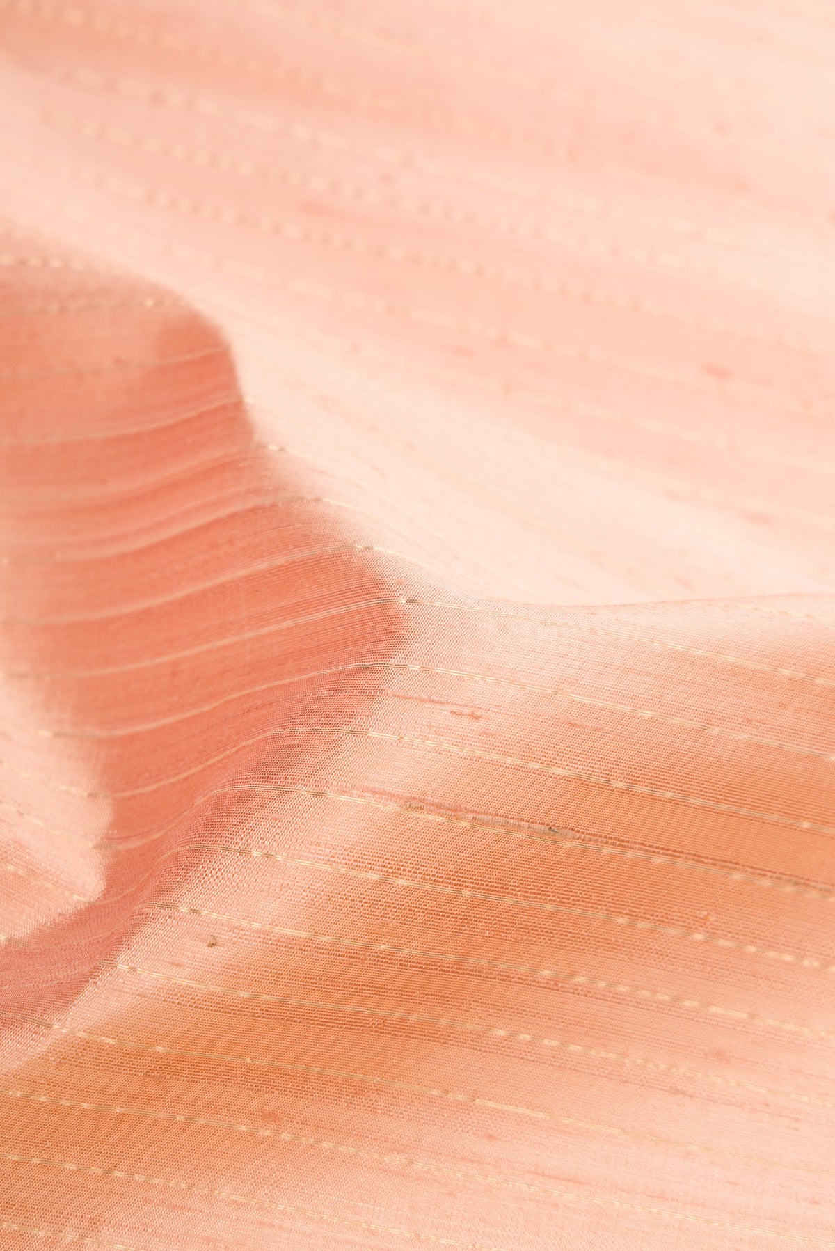 Close up of Rose pink Dual Tone Raw Silk Saree with Stripes on the body and Temple Border.  displaying folds