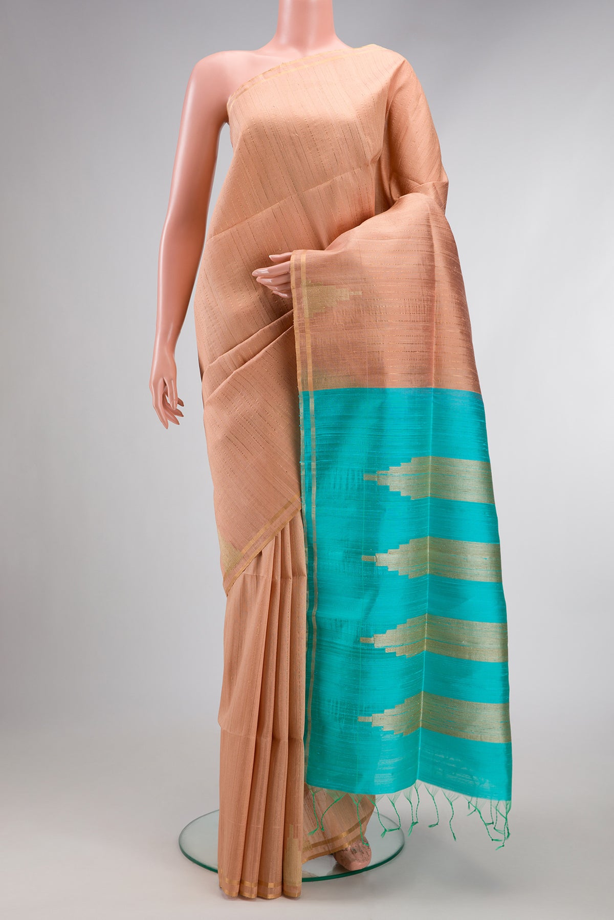 Rose Gold Dual Tone Raw Silk Saree with Stripes on the body and Zari Border.  displayed on a mannequin