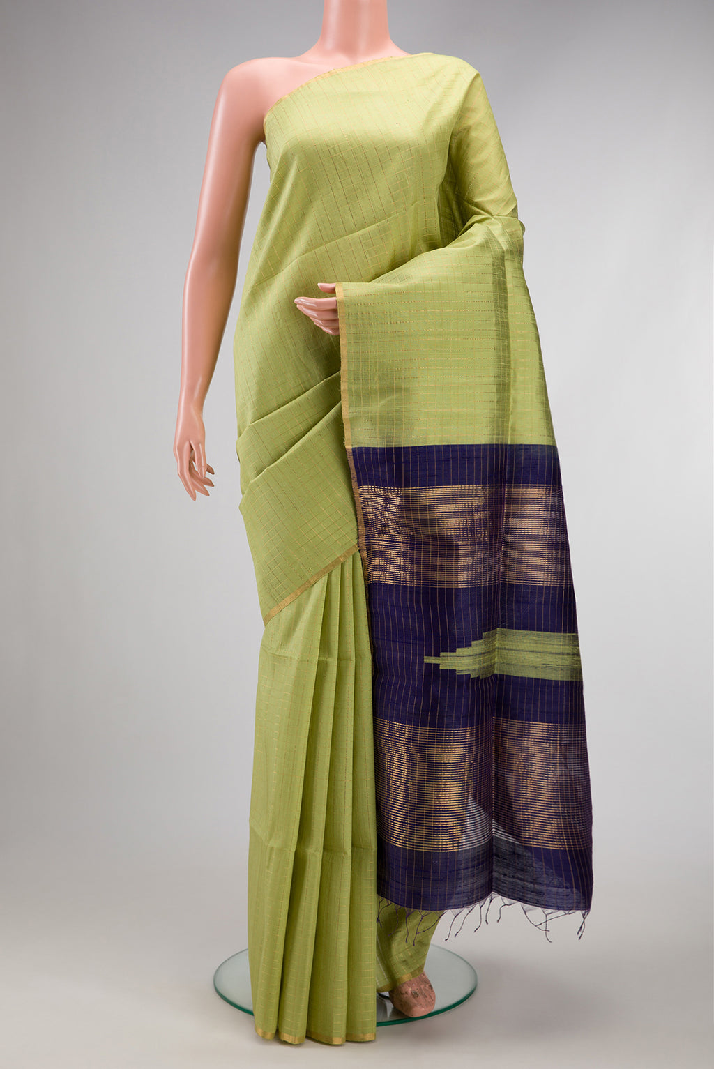 Pista Green Raw Silk Saree with Checked design on the body and Zari Border.  displayed on a mannequin