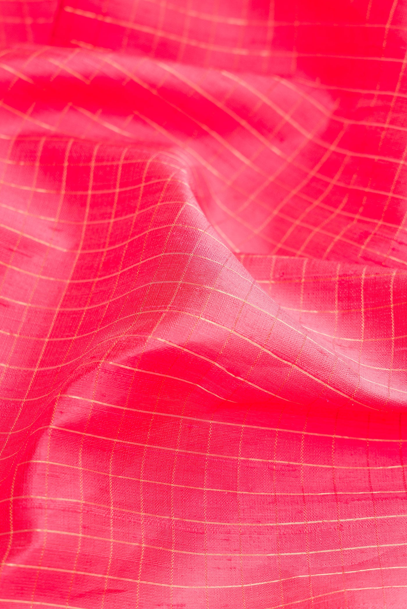 Close up of Pink Dual Tone Raw Silk Saree with Checked design on the body and Zari Border.  displaying folds