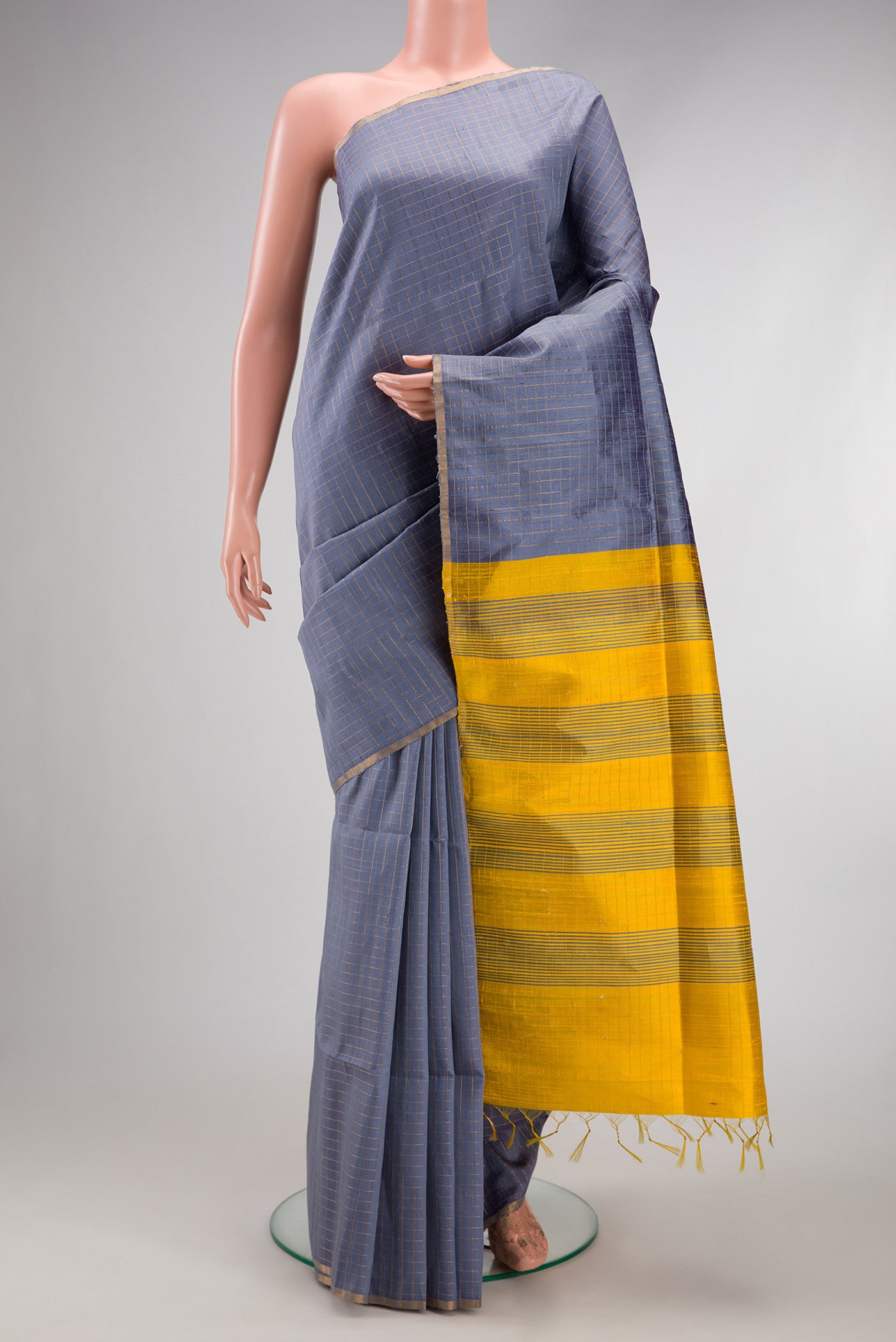 Grey Raw Silk Saree with Checked design on the body and Zari Border.  displayed on a mannequin