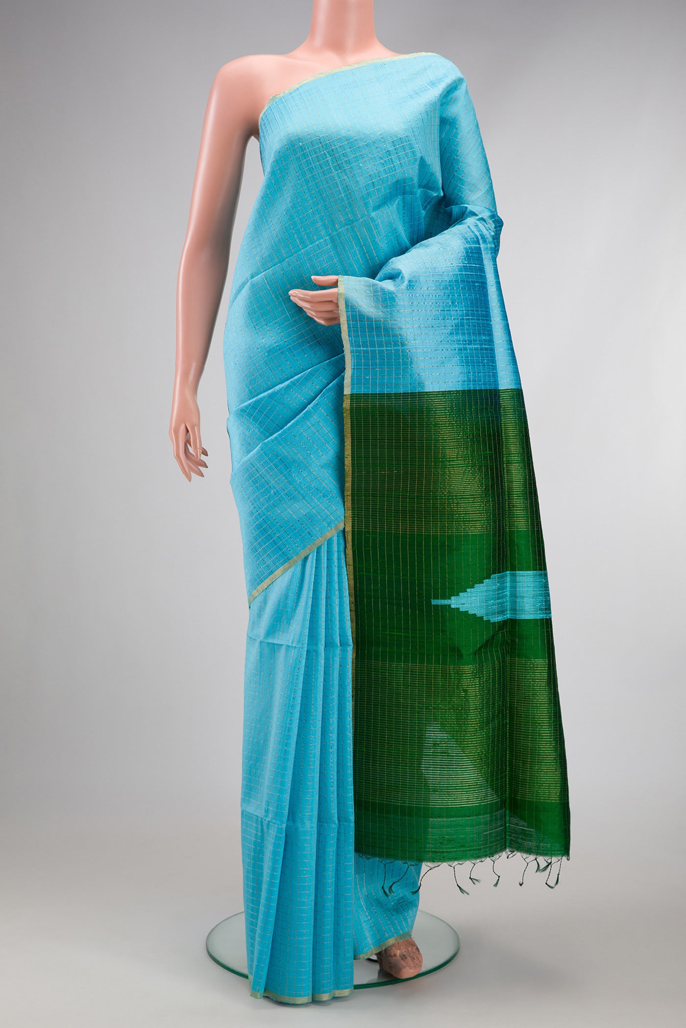 Sky Blue Raw Silk Saree with Checked design on the body and Zari Border.  displayed on a mannequin