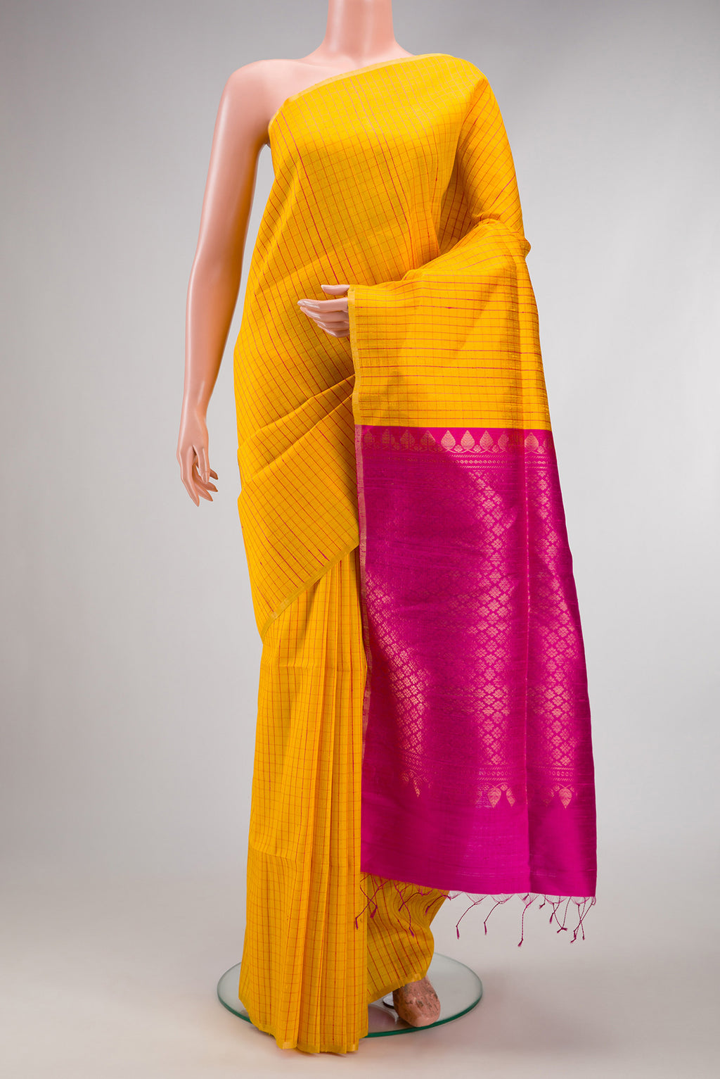 Yellow Dual Tone Raw Silk Saree with Checked design on the body and Zari Border.  displayed on a mannequin