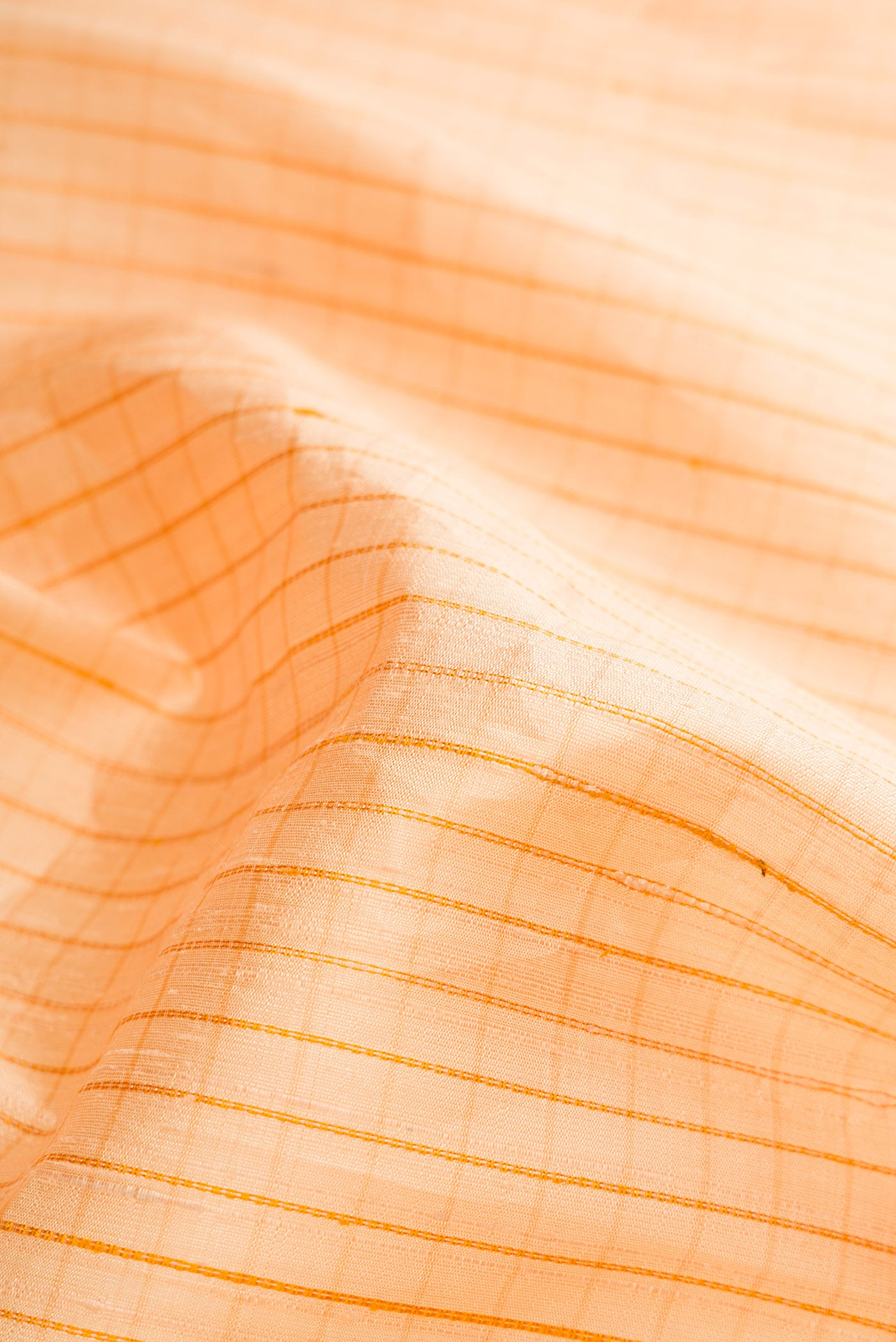 Close up of Sandal Raw Silk Saree with Checked design on the body and Thin Zari Line.  displaying folds