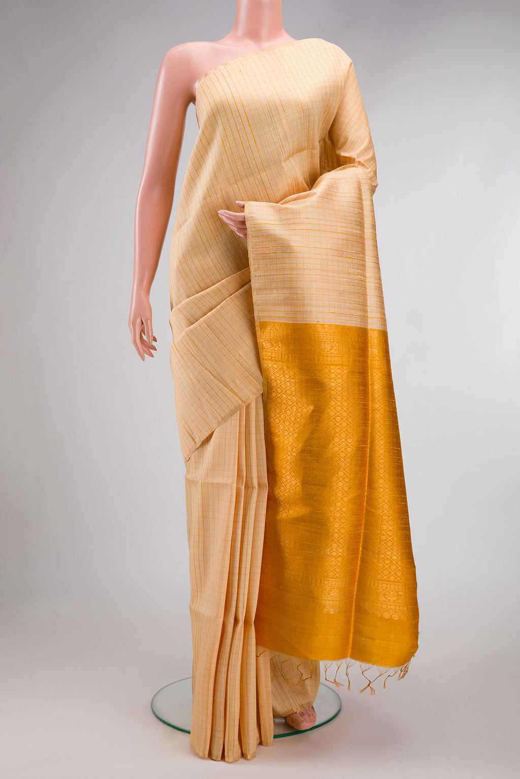 Sandal Raw Silk Saree with Checked design on the body and Thin Zari Line.  displayed on a mannequin