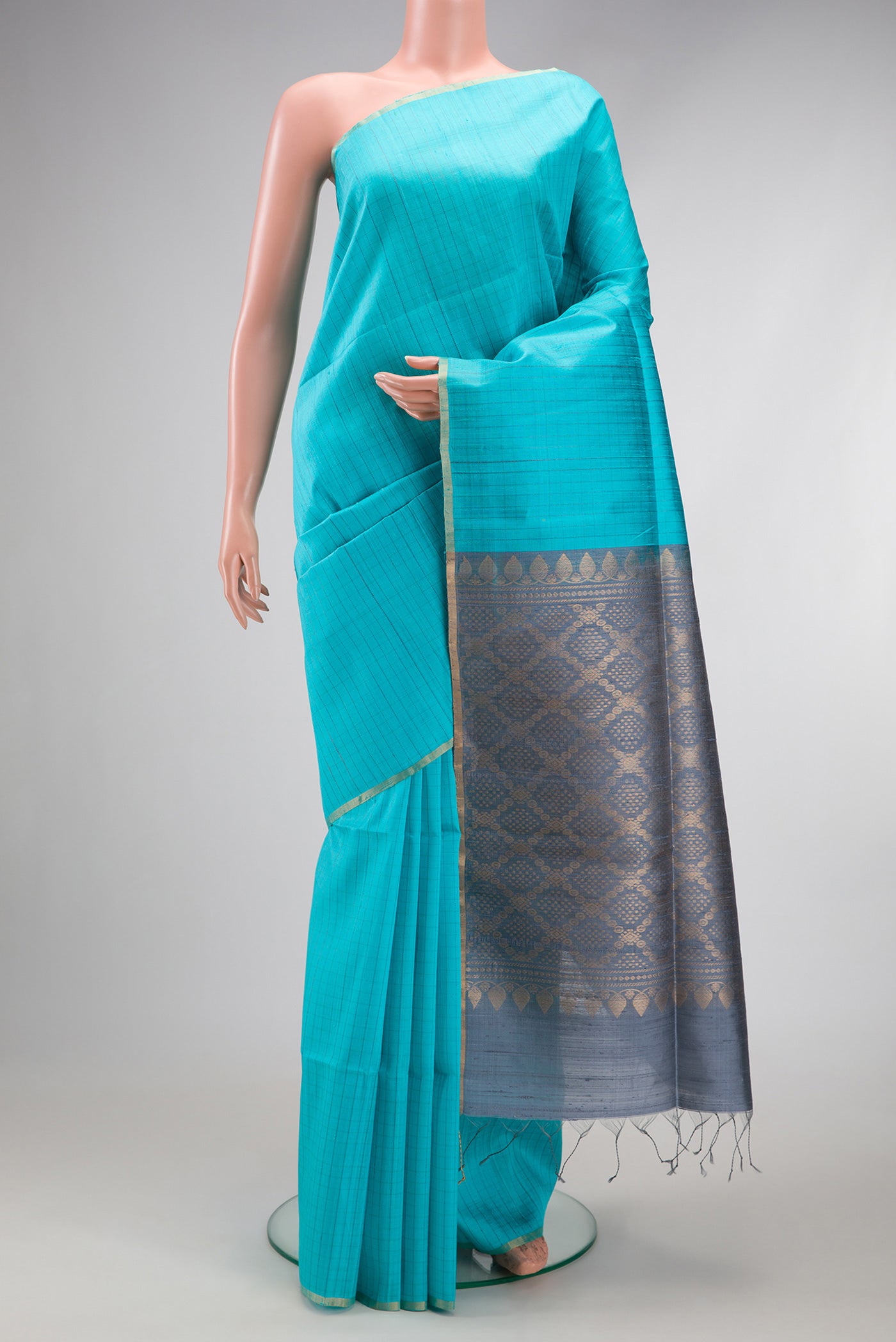 Sky Blue Raw Silk Saree with Checked design on the body and Zari Border.  displayed on a mannequin