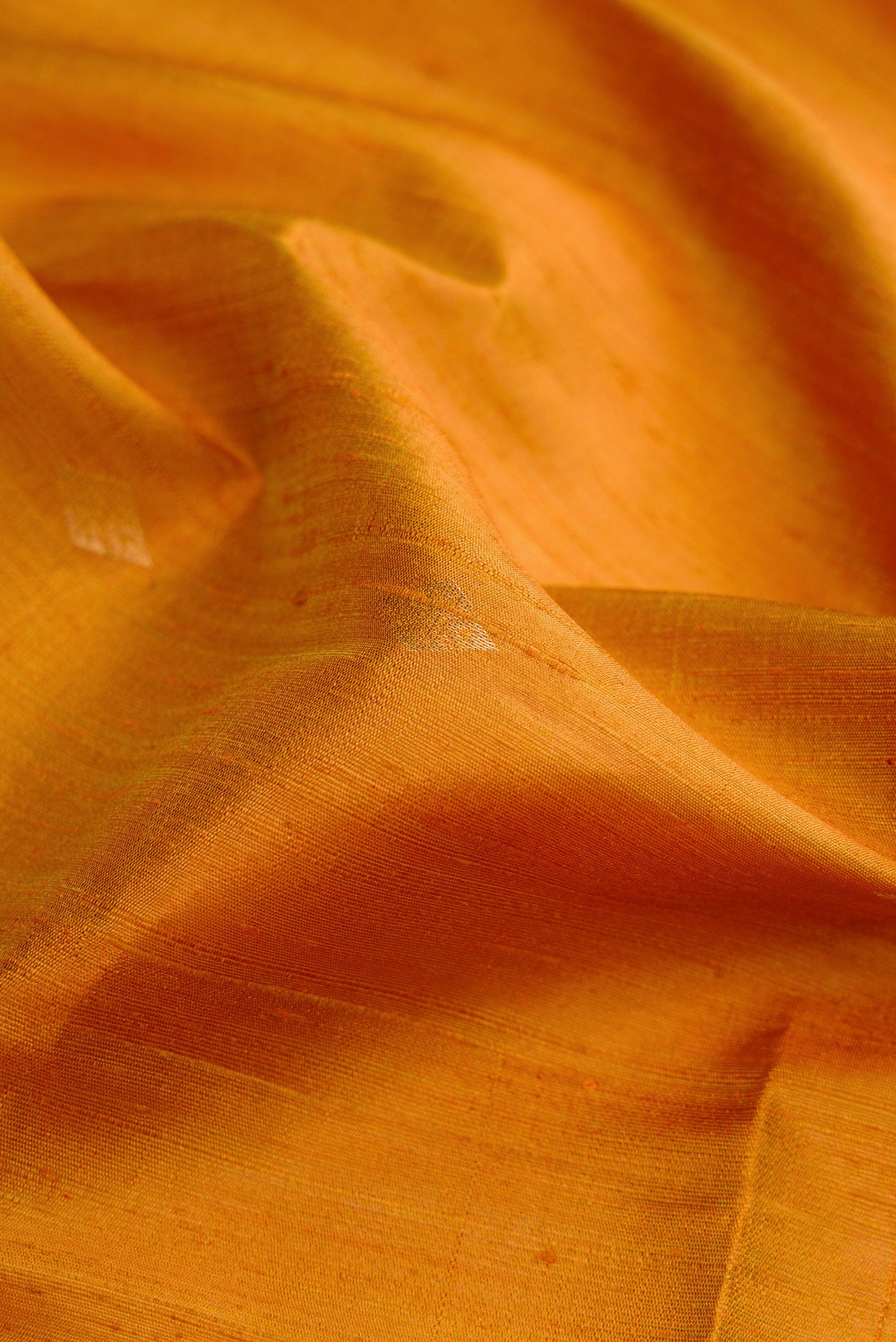 Close up of Mehandi Green Dual Tone Raw Silk Saree with Zari Butta on the body and Zari Border.  displaying folds