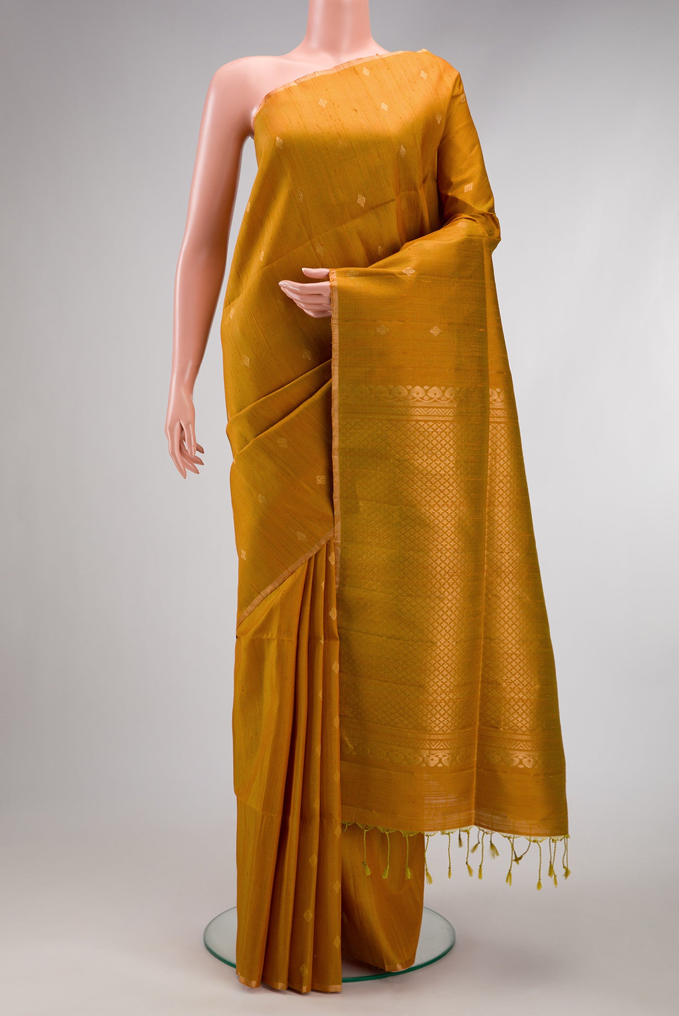 Mehandi Green Dual Tone Raw Silk Saree with Zari Butta on the body and Zari Border.  displayed on a mannequin