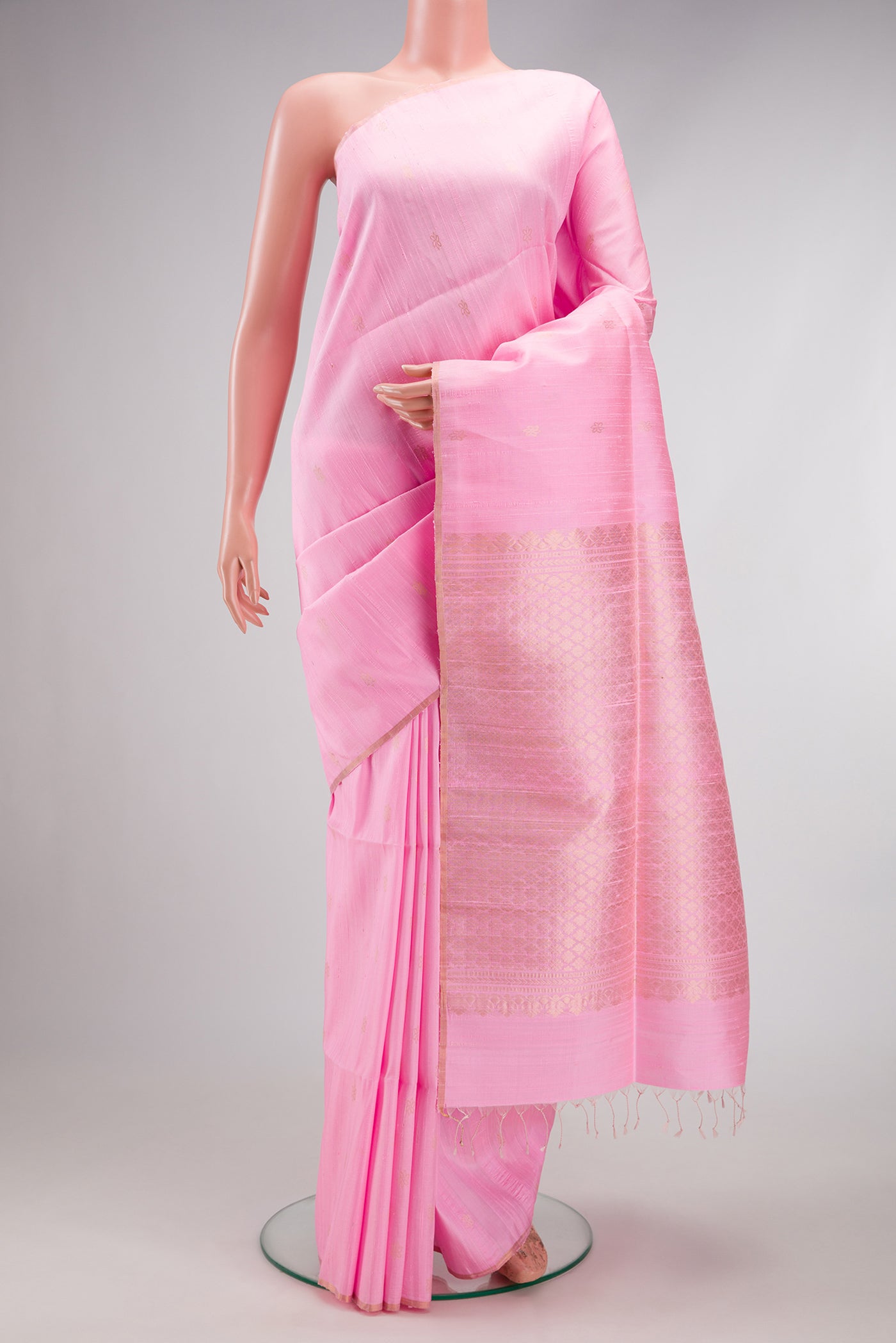 Rose pink Raw Silk Saree with Zari Butta on the body and Thin Zari Line.  displayed on a mannequin