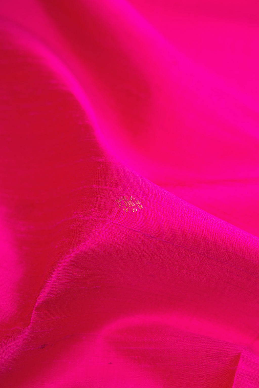 Close up of Pink Raw Silk Saree with Zari Butta on the body and Fancy Border.  displaying folds