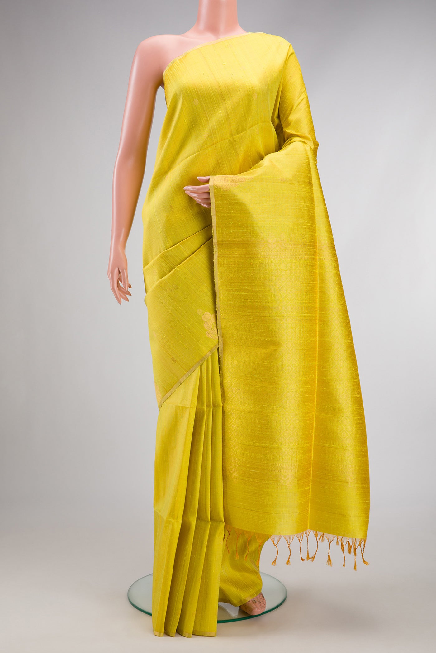 Lemon Yellow Dual Tone Raw Silk Saree with Zari Butta on the body and Zari Border.  displayed on a mannequin