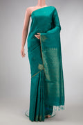 Peacock Blue Dual Tone Raw Silk Saree with Zari Butta on the body and Fancy Border.  displayed on a mannequin