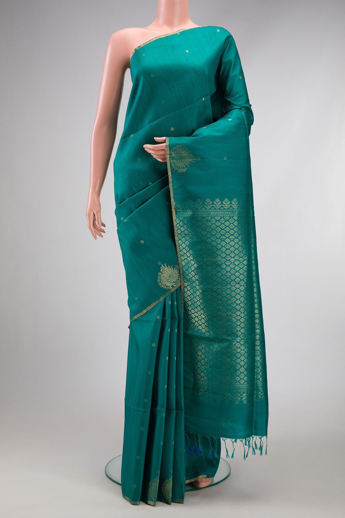 Peacock Blue Dual Tone Raw Silk Saree with Zari Butta on the body and Fancy Border.  displayed on a mannequin