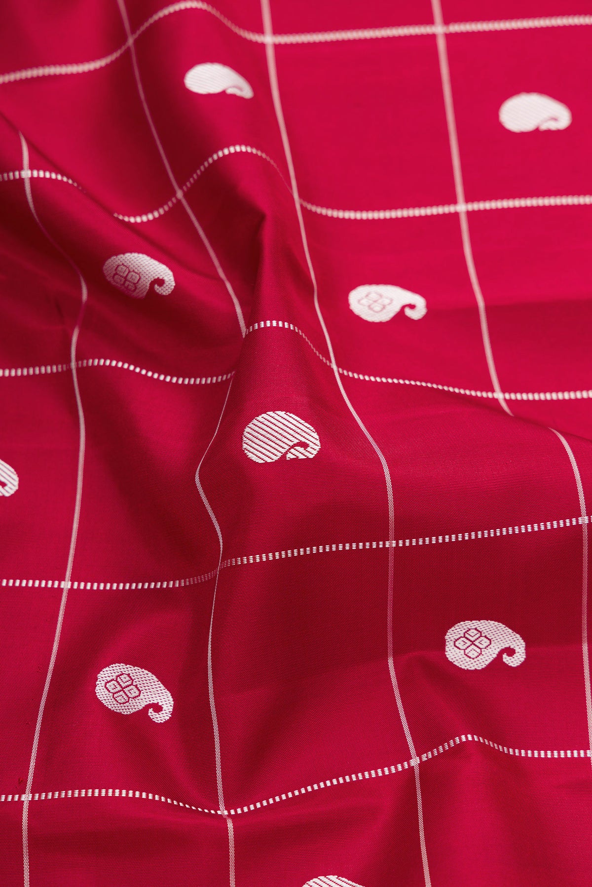 Close up of Maroon Dual Tone Kanjivaram Silk Saree with Checked design on the body and Fancy Border.  displaying folds