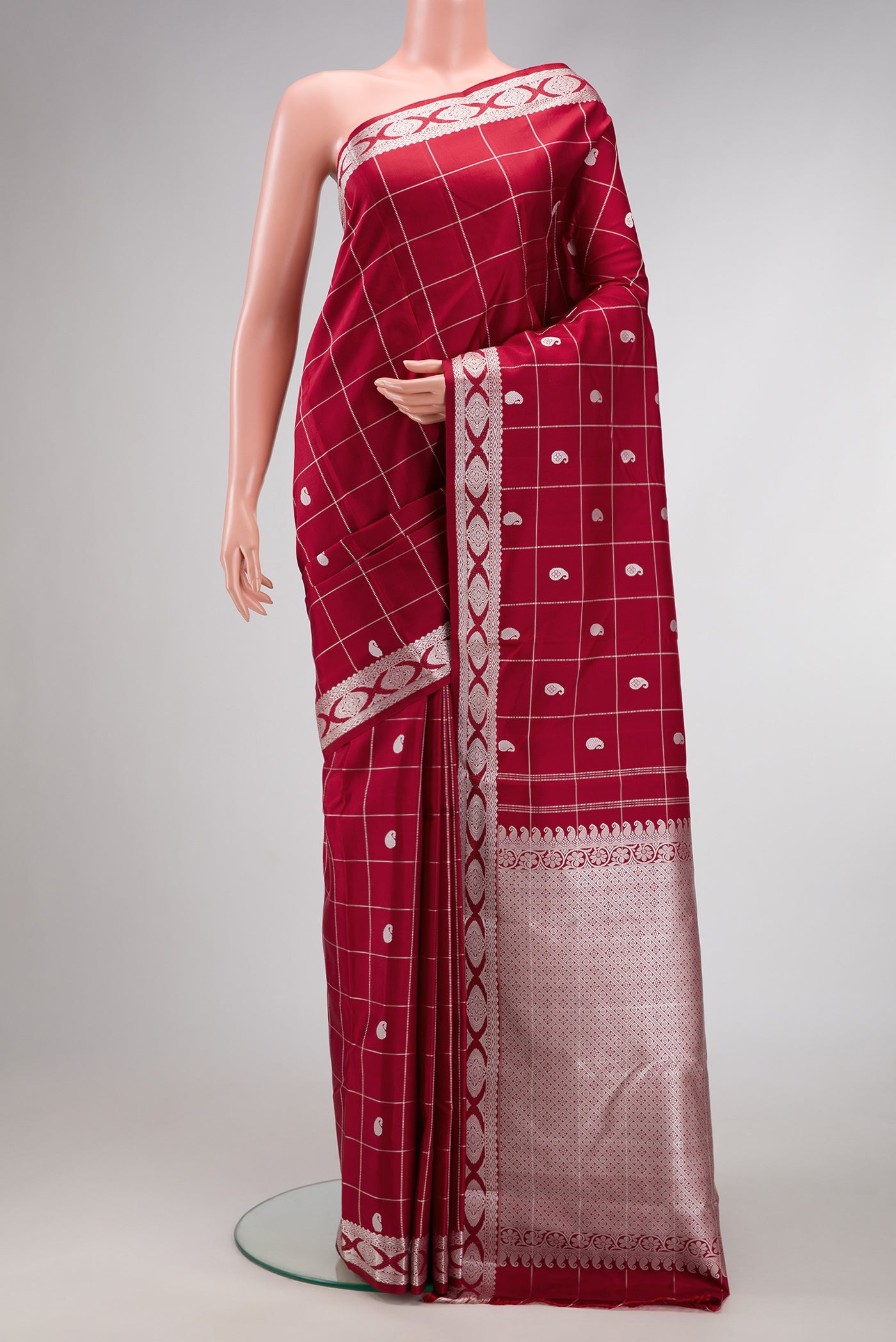Maroon Dual Tone Kanjivaram Silk Saree with Checked design on the body and Fancy Border.  displayed on a mannequin