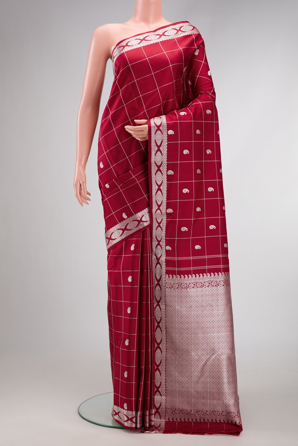 Maroon Dual Tone Kanjivaram Silk Saree with Checked design on the body and Fancy Border.  displayed on a mannequin