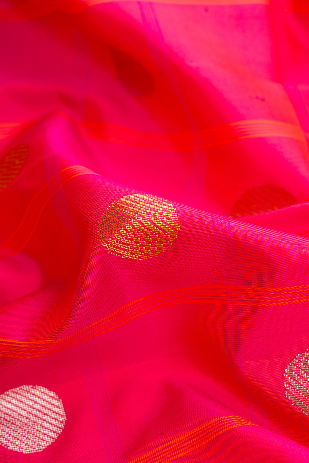 Close up of Pure Silk Pure Zari Coral Dual Tone Kanjivaram Saree with Checked design on the body and Zari Border.  displaying folds