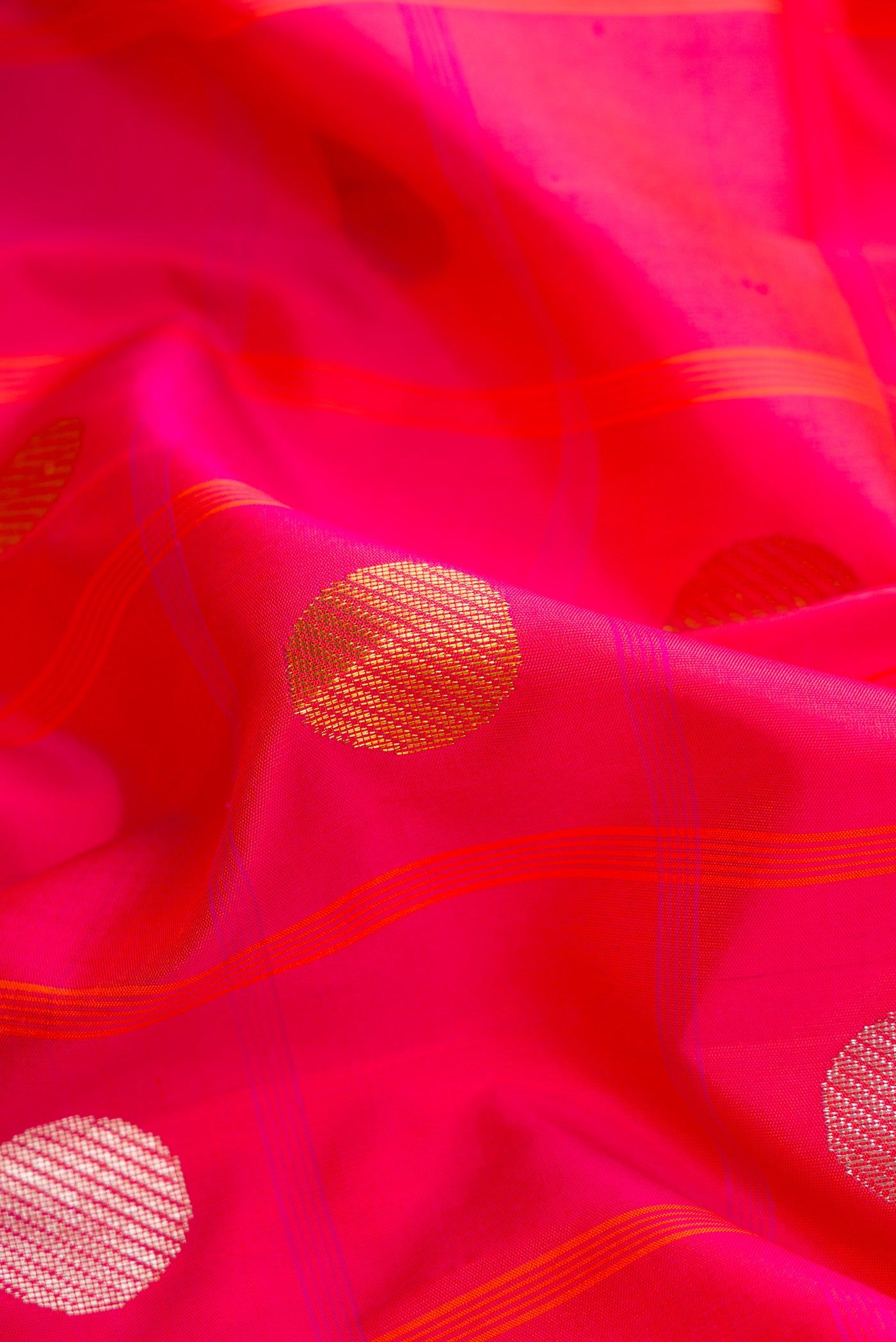 Close up of Pure Silk Pure Zari Coral Dual Tone Kanjivaram Saree with Checked design on the body and Zari Border.  displaying folds