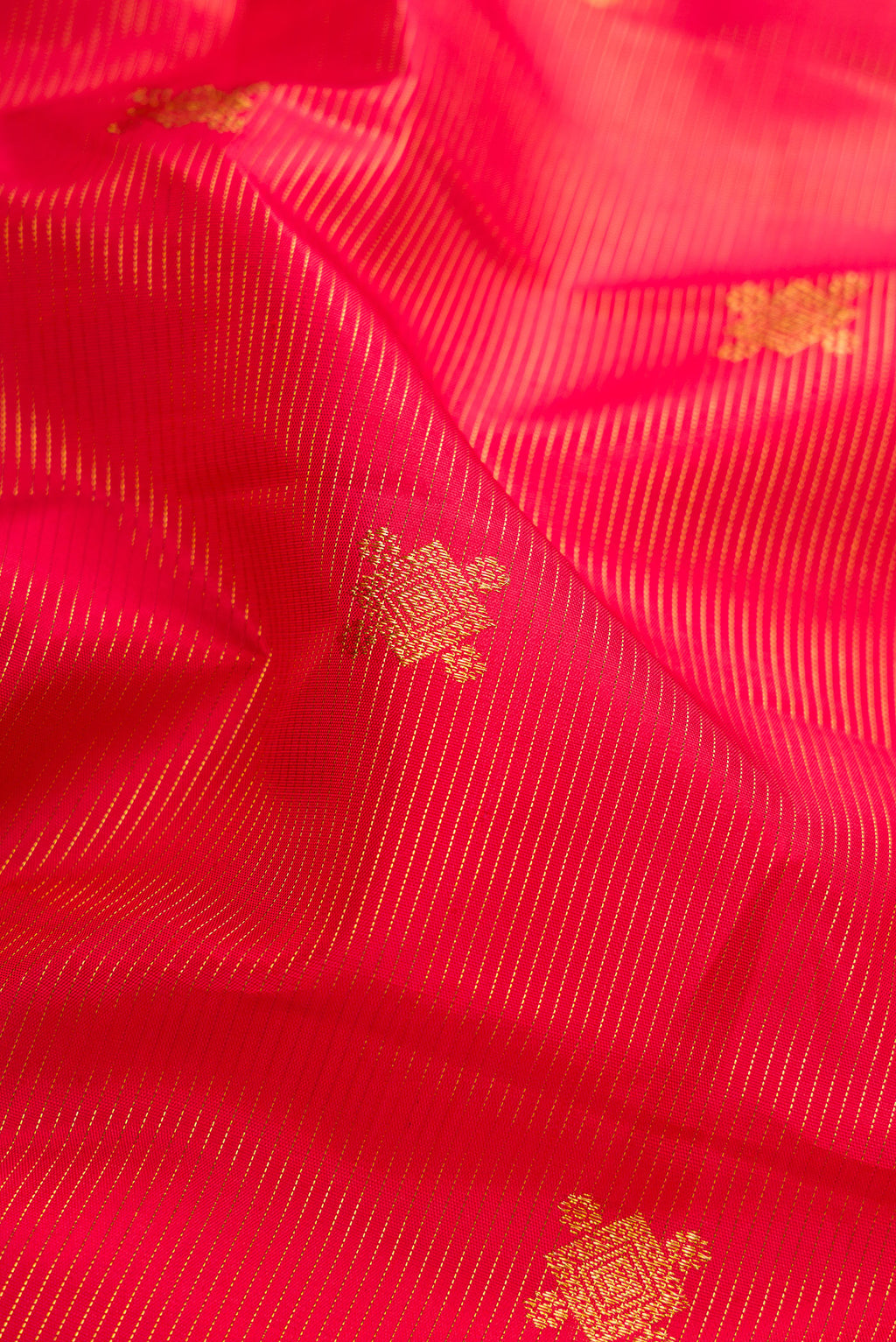 Close up of Pure Silk Pure Zari Red Dual Tone Kanjivaram Saree with Stripes on the body and Zari Border.  displaying folds