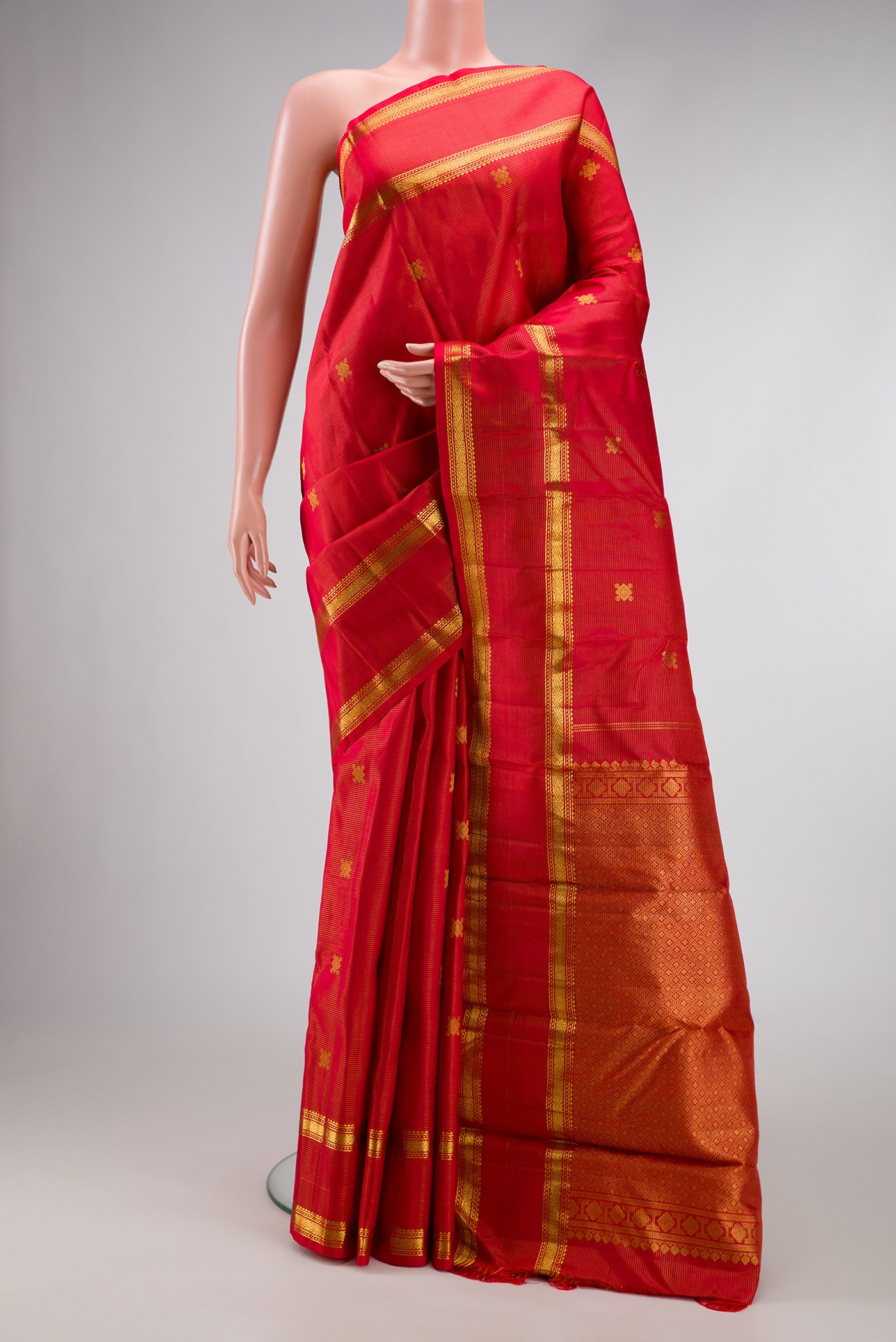 Pure Silk Pure Zari Red Dual Tone Kanjivaram Saree with Stripes on the body and Zari Border.  displayed on a mannequin