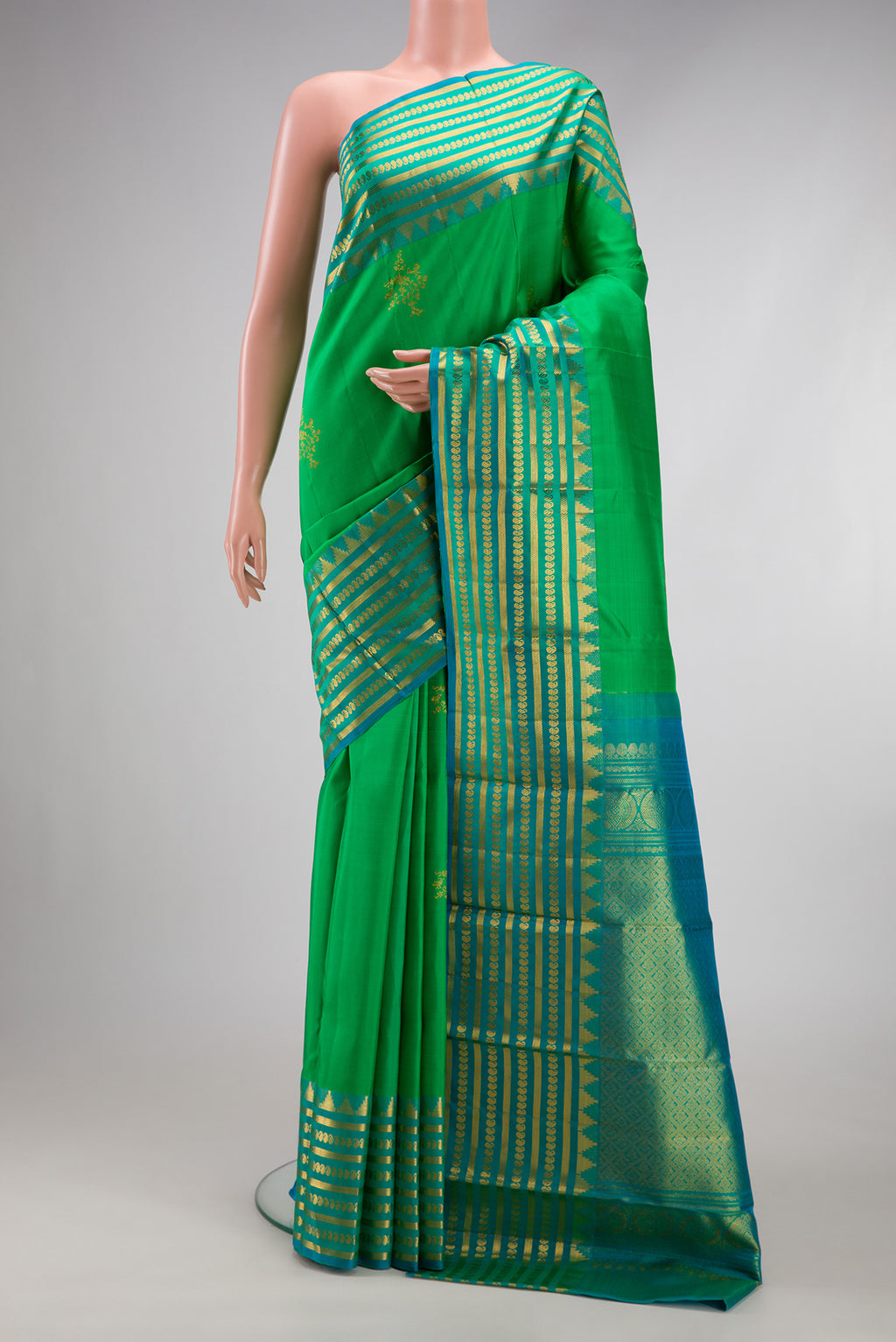 Green Kanchipuram Silk Saree with Zari Butta on the body and Fancy Border.  displayed on a mannequin