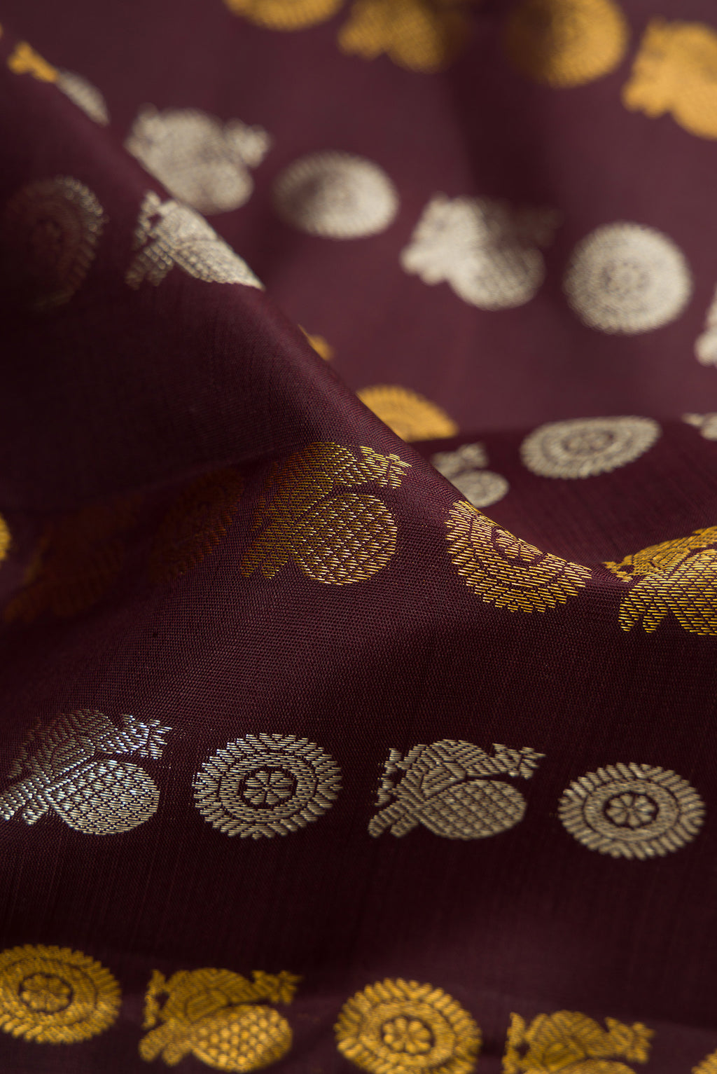 Close up of Coffee Brown Kanjivaram Silk Saree with Zari Butta on the body and Zari Border.  displaying folds