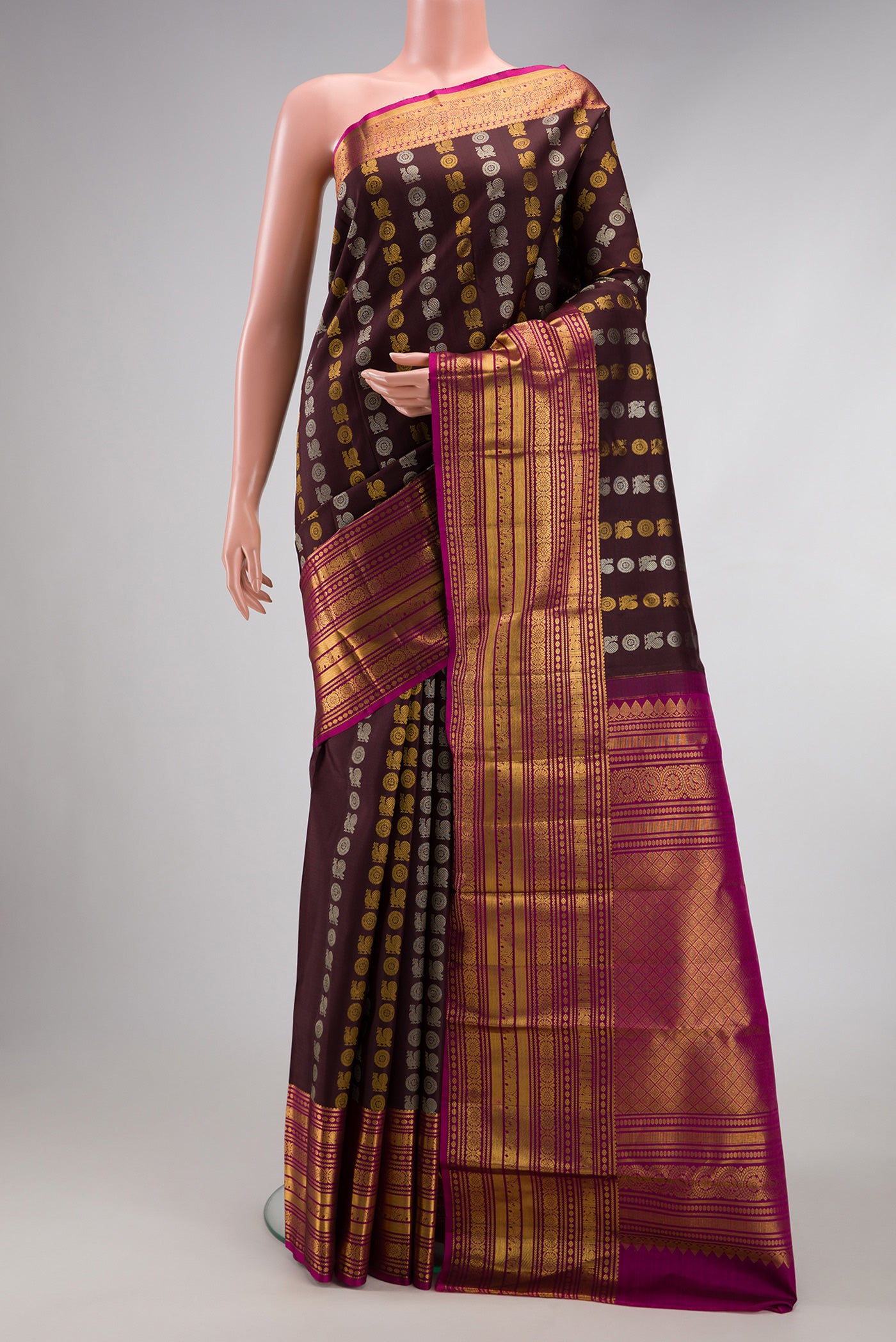 Coffee Brown Kanjivaram Silk Saree with Zari Butta on the body and Zari Border.  displayed on a mannequin