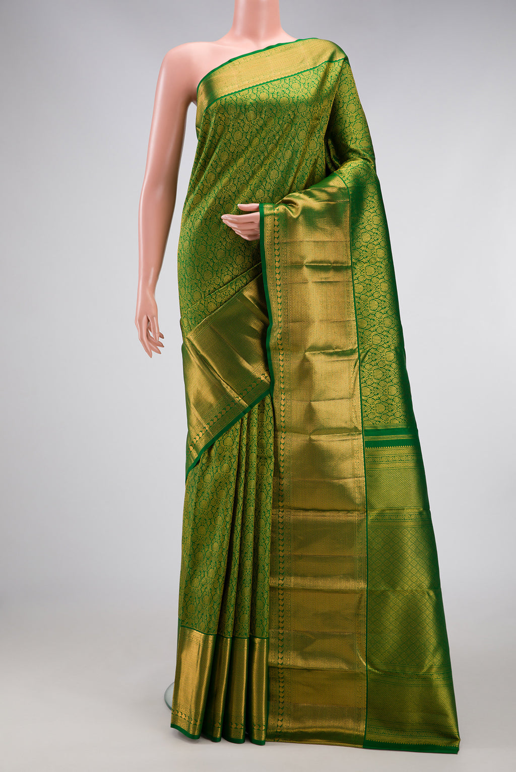 Green Kanchipuram Silk Saree with Zari Brocade on the body and Zari Border.  displayed on a mannequin