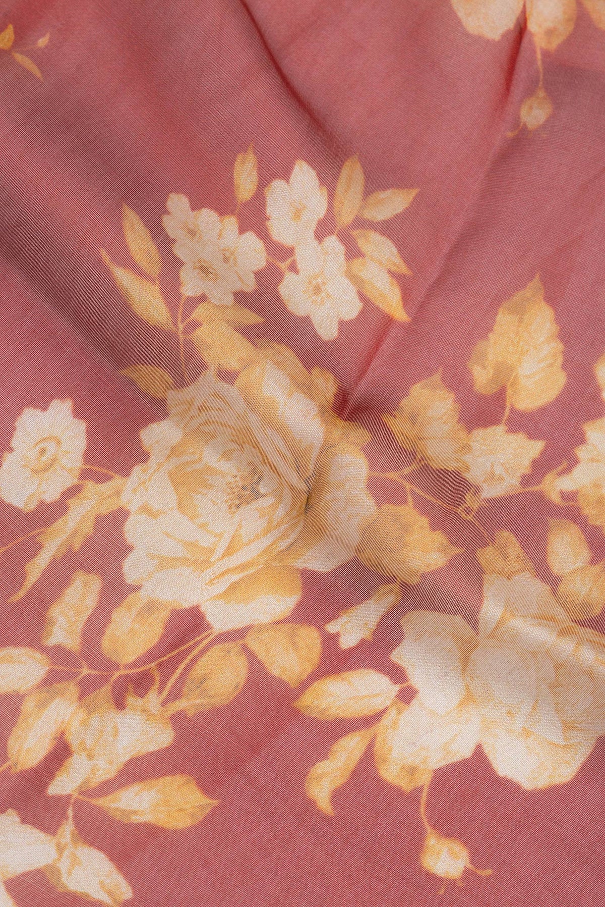 Close up of Rust Organza Silk Saree with Printed design on the body and Zari Border.  displaying folds