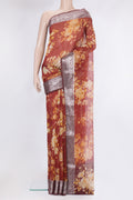 Rust Organza Silk Saree with Printed design on the body and Zari Border.  displayed on a mannequin
