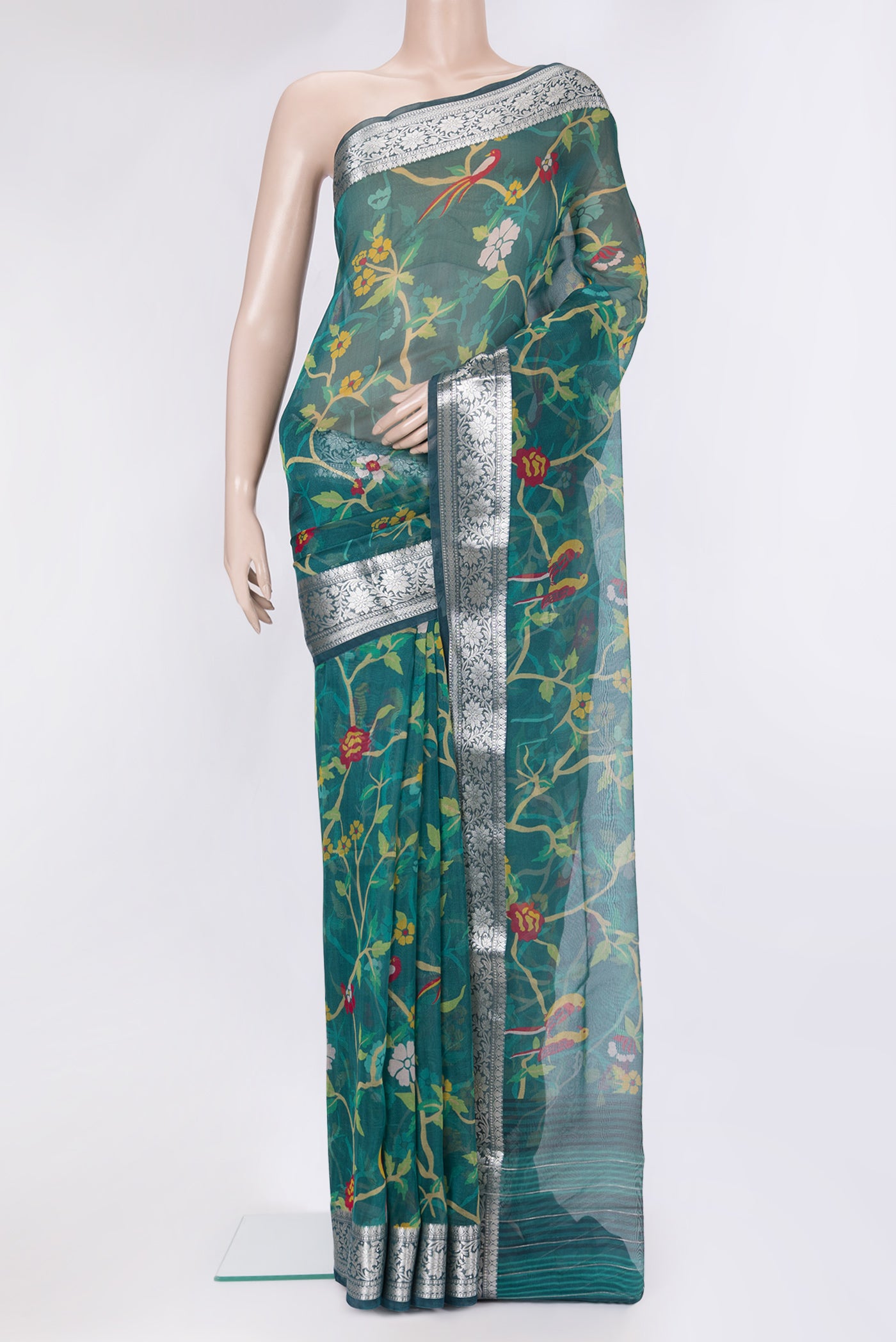 Peacock Blue Organza Silk Saree with Bird Print on the body and Zari Border.  displayed on a mannequin