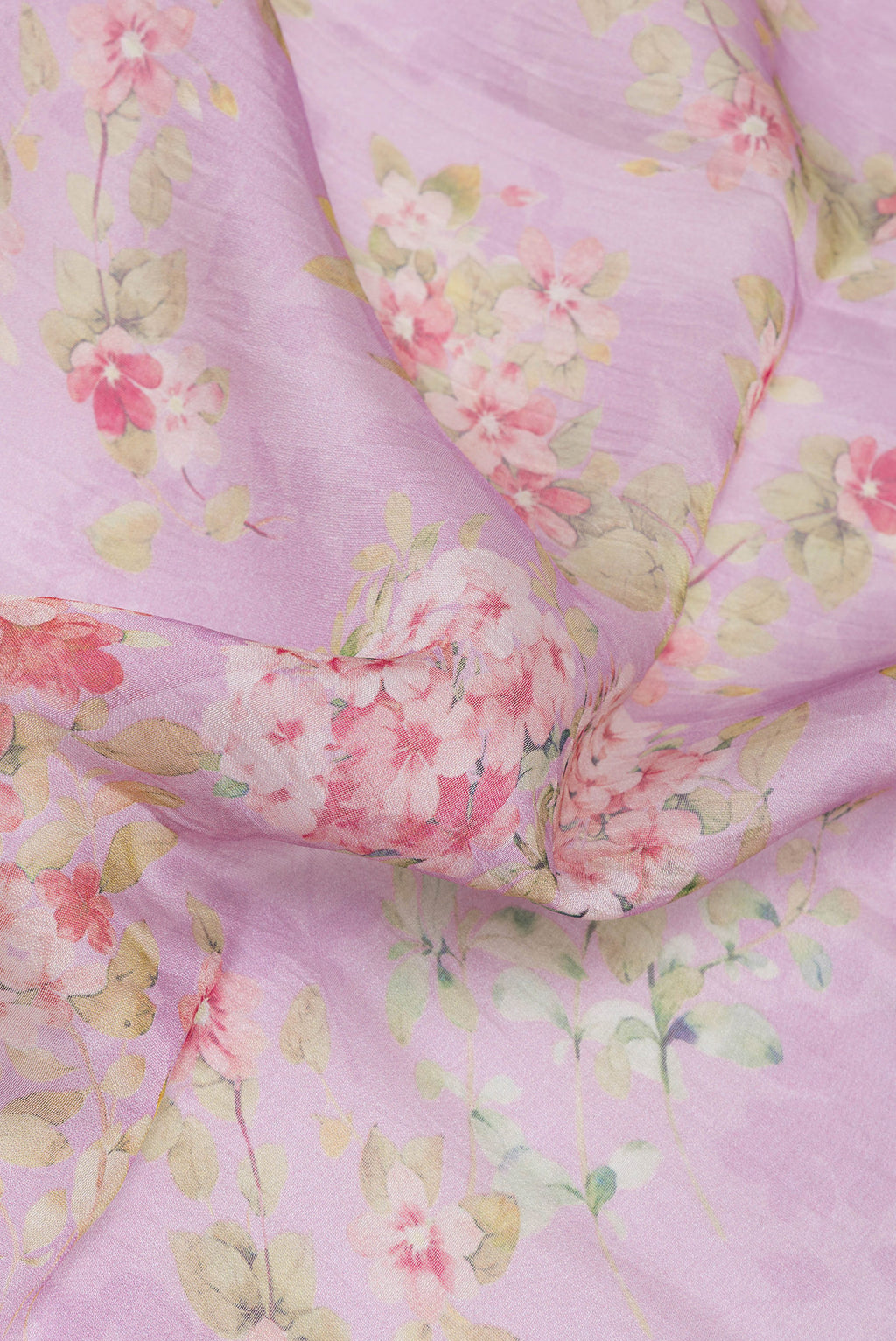 Close up of Lavender Organza Silk Saree with Floral Print on the body and Zari Border.  displaying folds