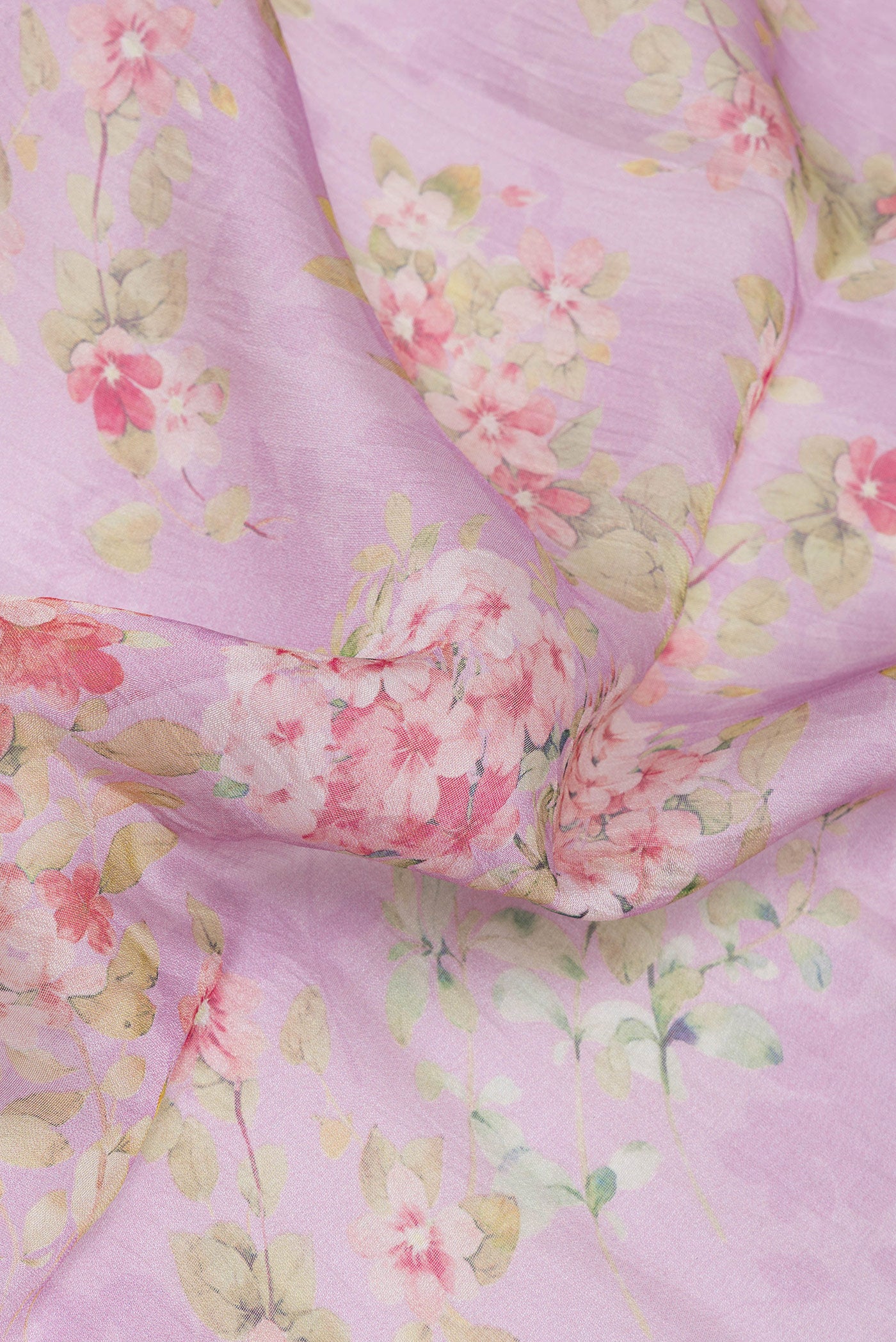 Close up of Lavender Organza Silk Saree with Floral Print on the body and Zari Border.  displaying folds