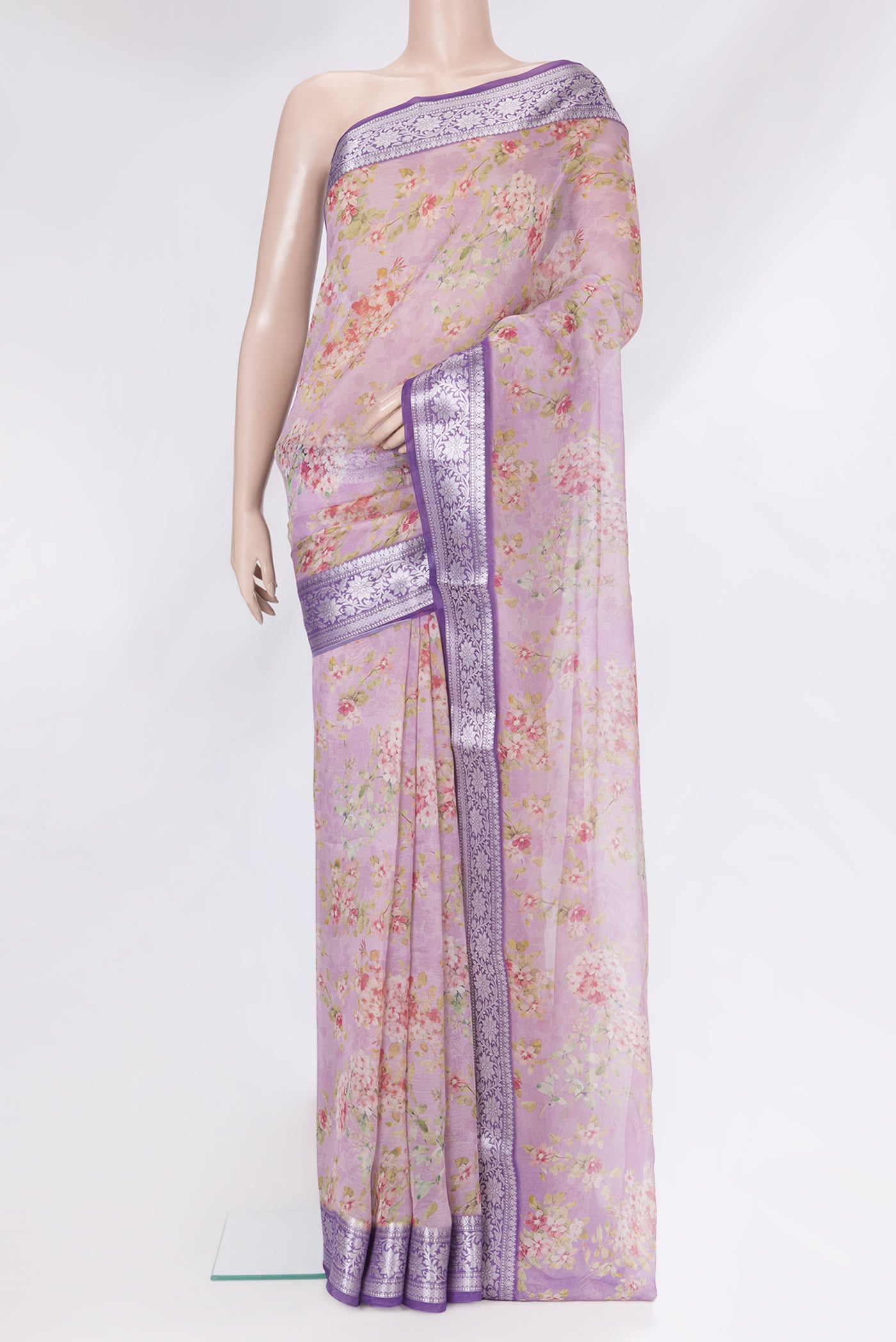 Lavender Organza Silk Saree with Floral Print on the body and Zari Border.  displayed on a mannequin