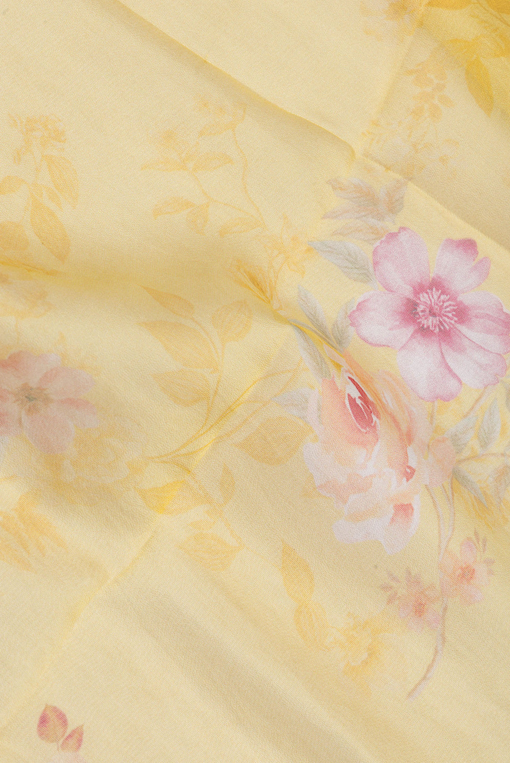 Close up of Yellow Organza Silk Saree with Floral Print on the body and Zari Border.  displaying folds