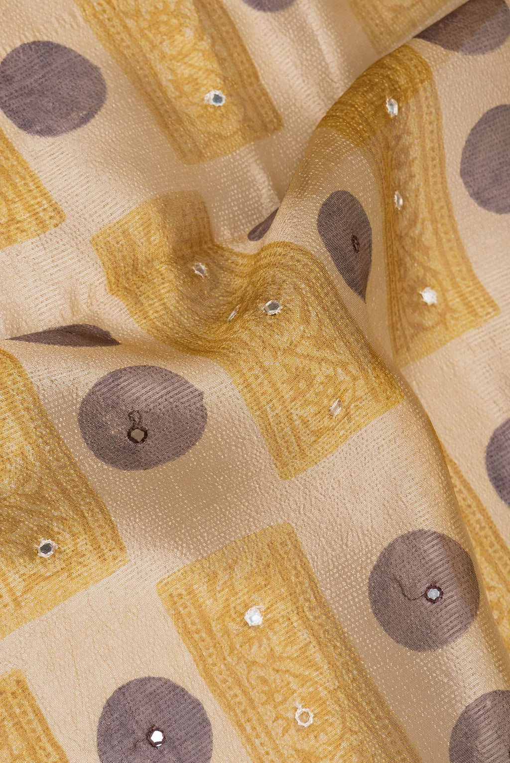 Close up of Beige Tussar Saree with Printed design on the body and Zari And Thread Border.  displaying folds