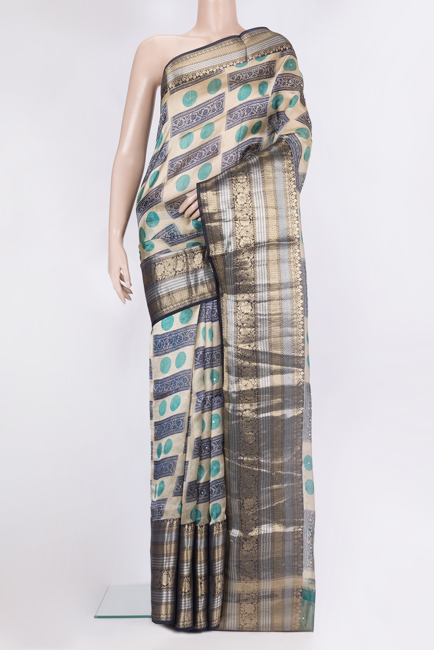 Beige Tussar Saree with Printed design on the body and Zari And Thread Border.  displayed on a mannequin
