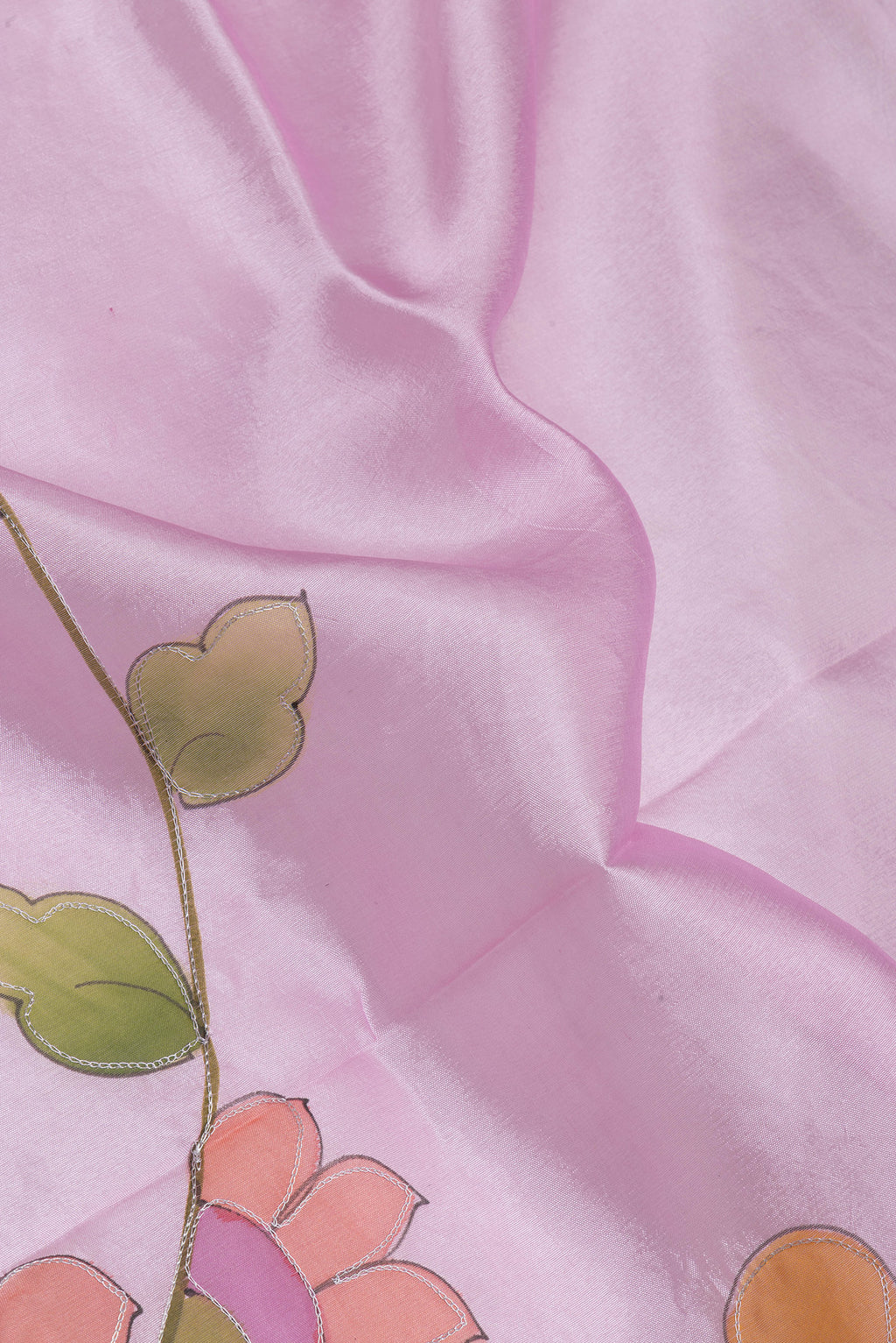 Close up of Pink Tussar Silk Saree with Embroidery on the body and Zari Border.  displaying folds
