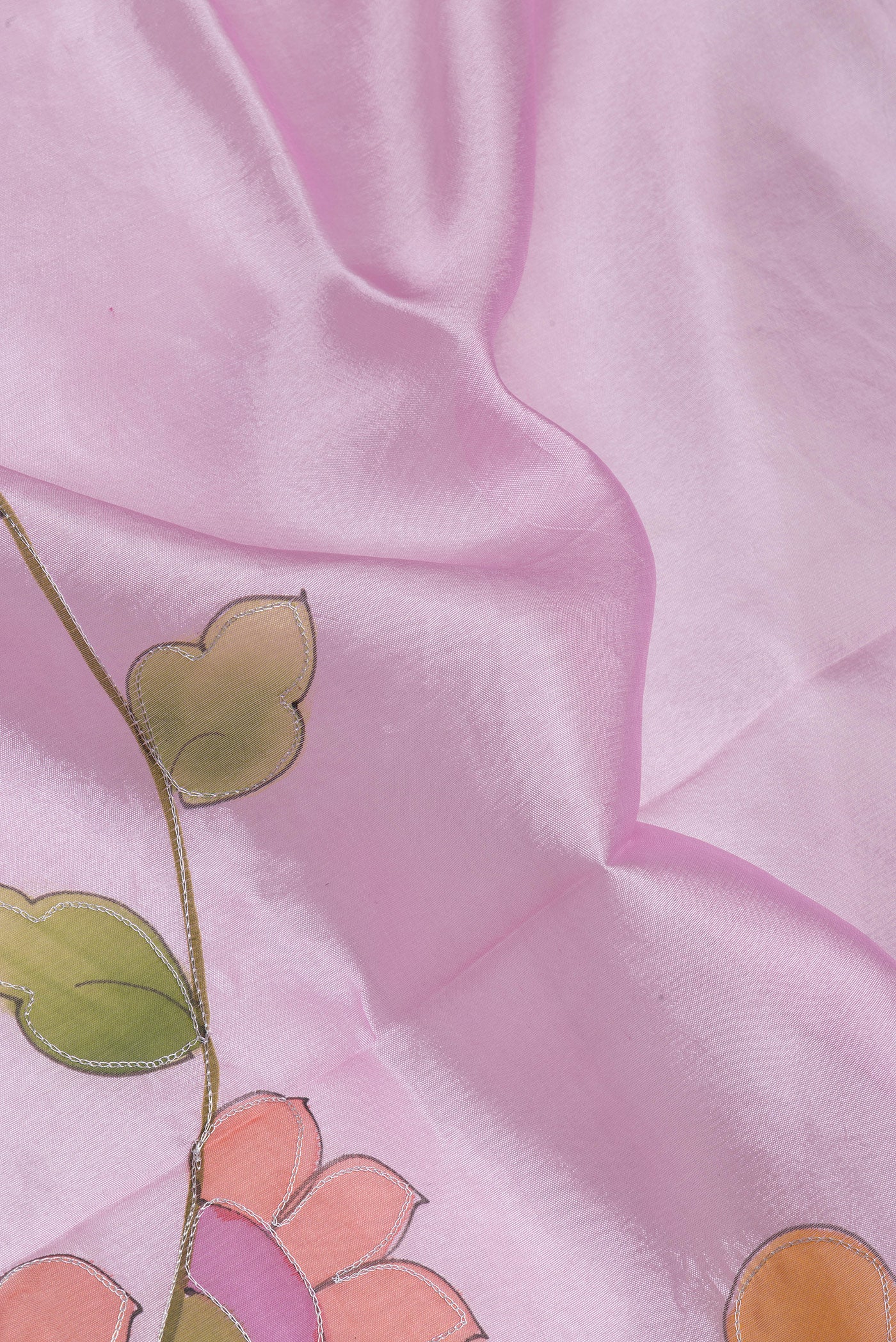 Close up of Pink Tussar Silk Saree with Embroidery on the body and Zari Border.  displaying folds