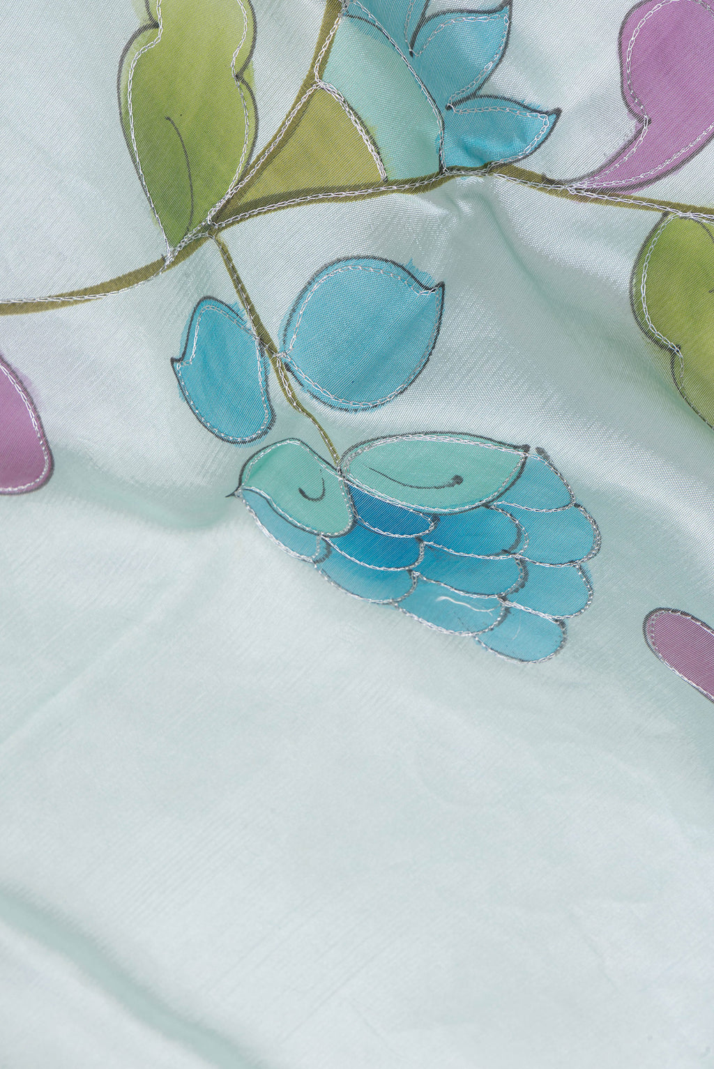 Close up of Sky Blue Tussar Silk Saree with Embroidery on the body and Zari Border.  displaying folds