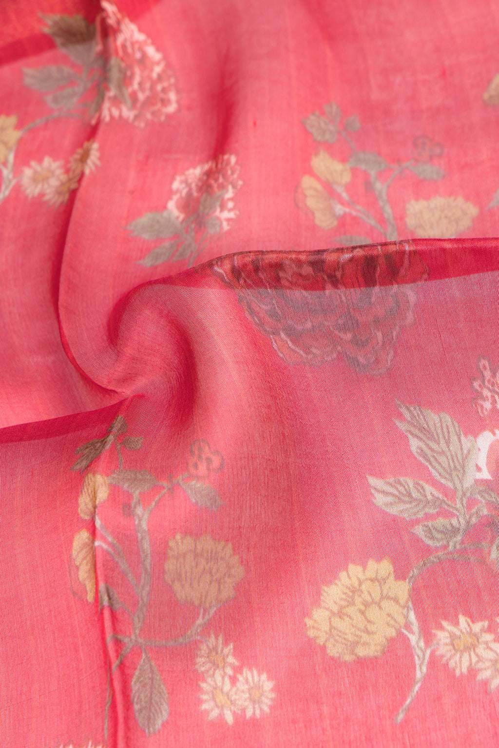 Close up of Red Organza Silk Saree with Printed design on the body and Fancy Border.  displaying folds