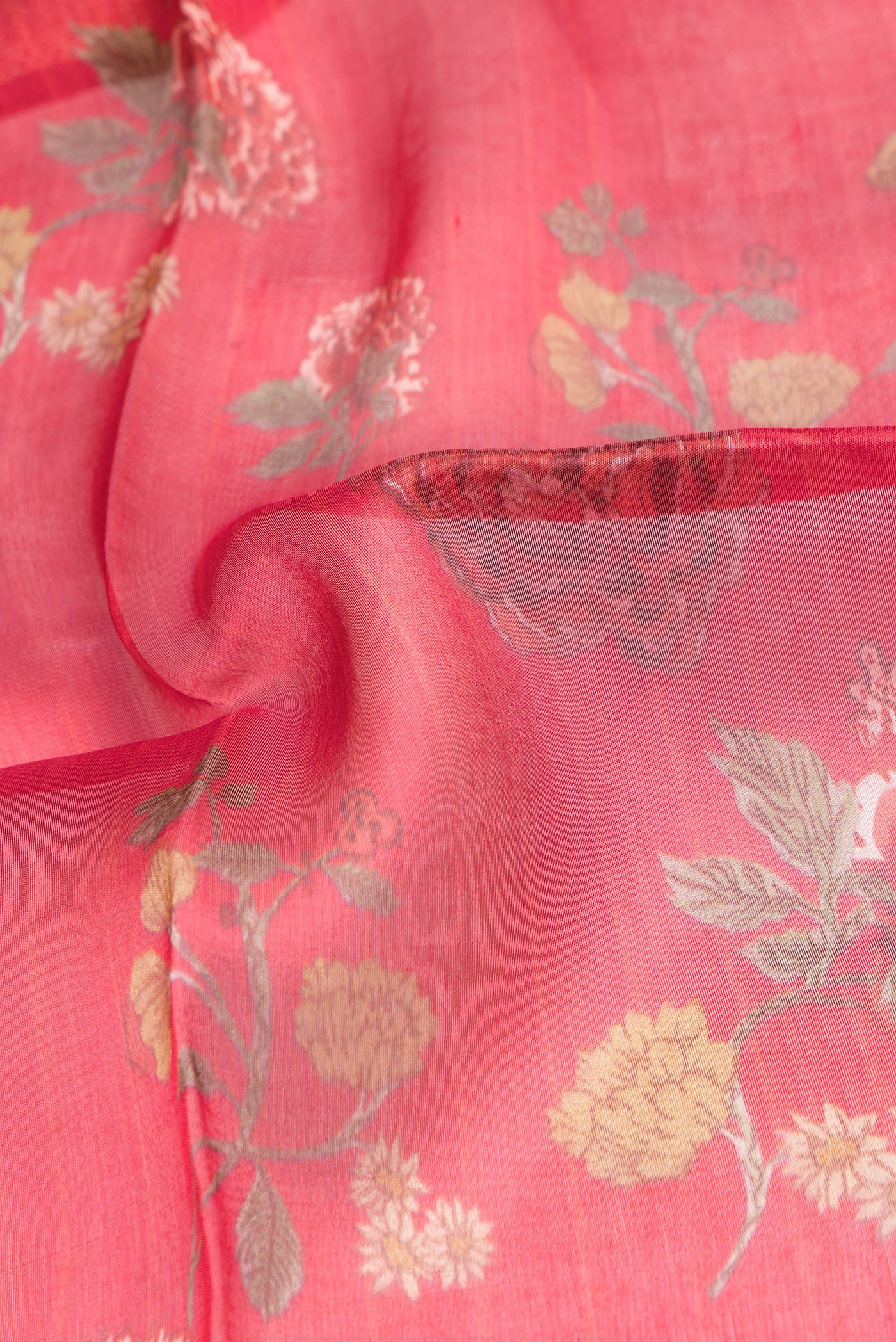 Close up of Red Organza Silk Saree with Printed design on the body and Fancy Border.  displaying folds