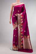 Magenta Dual Tone Banarasi Silk Saree with Zari And Thread Butta on the body and Fancy Border.  displayed on a mannequin